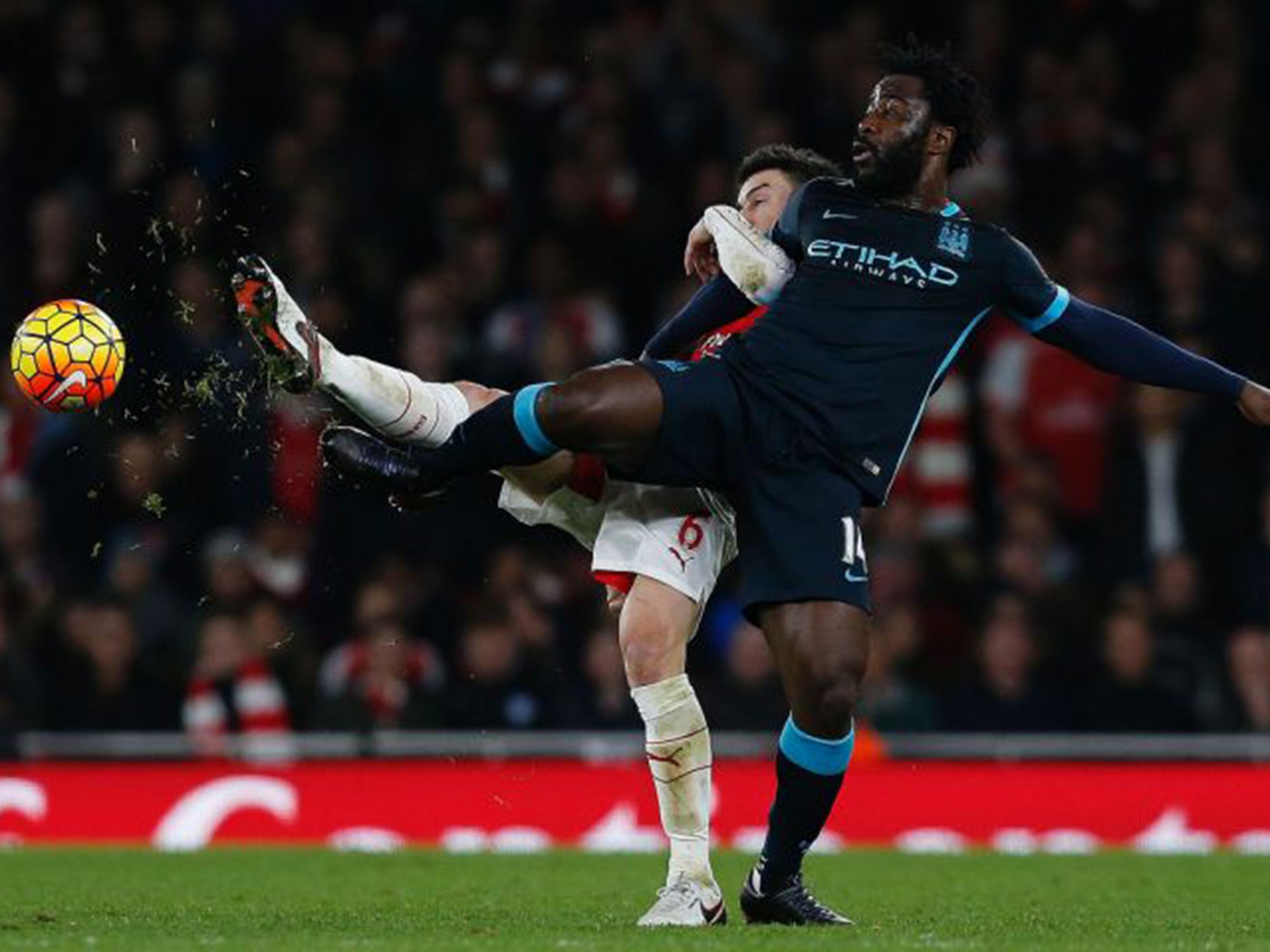 Wilfried Bony vies with Arsenal defender Laurent Koscielny in Monday night's defeat