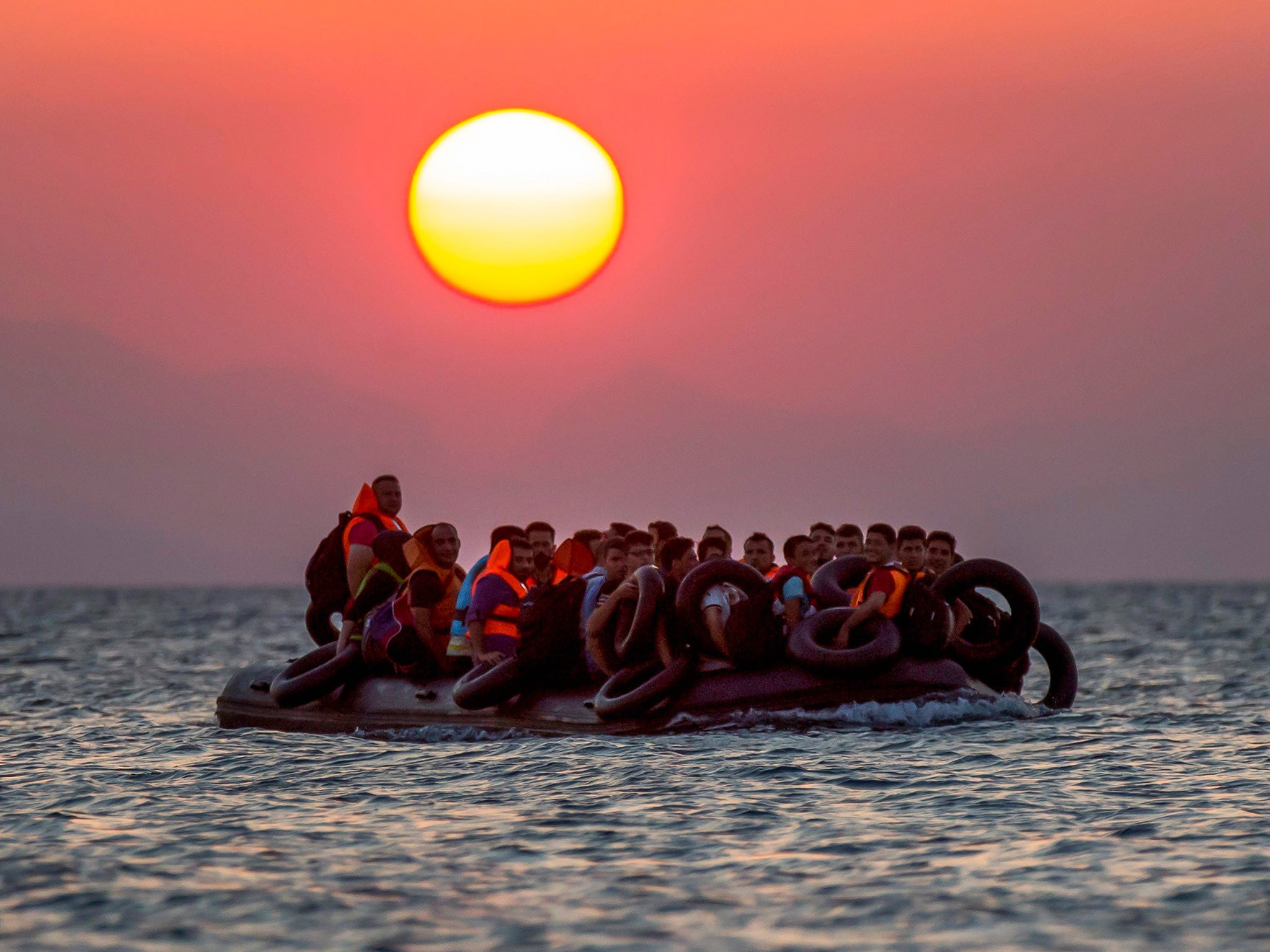 Refugees on a dinghy arrive at the southeastern island of Kos, Greece, after crossing from Turkey