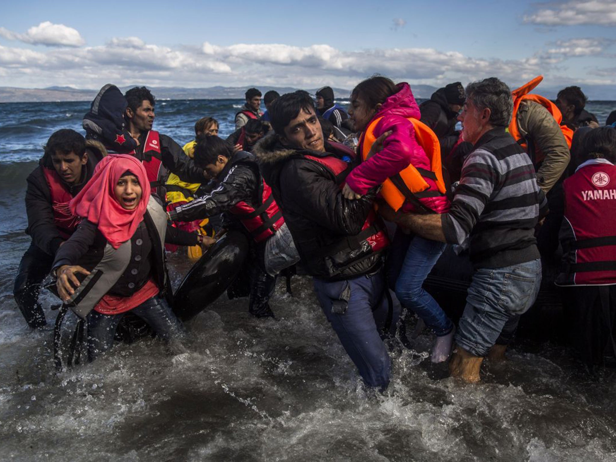 Afghans arrive on the island of Lesbos after crossing the Aegean Sea from Turkey in bad weather. More than 800,000 refugees are said to have entered Greece by sea this year