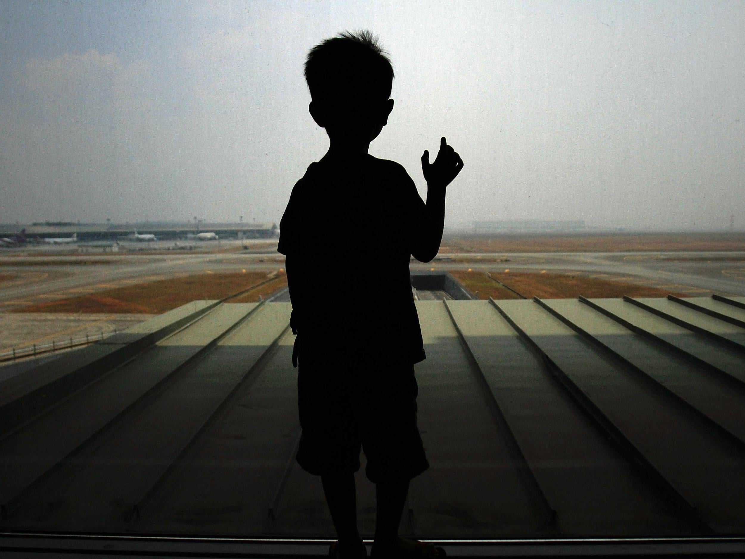 A boy waits for his family members arrival at Kuala Lumpur International Airport