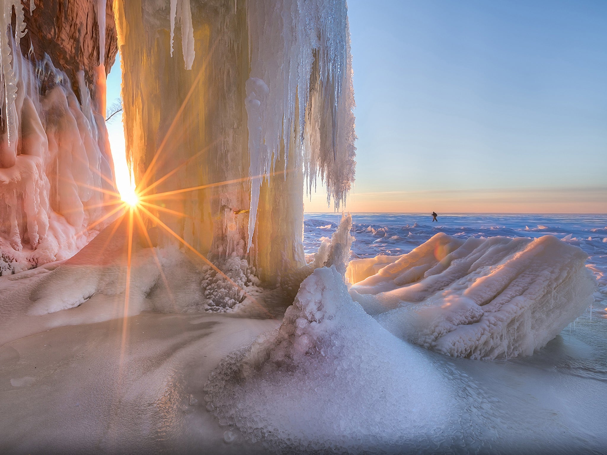 "Shining Through by Ernie Vater": The setting sun shines through the ice on the shore of a frozen Lake Superior, traversed by Your Shot member Ernie Vater to reach this spot. “Part of the beauty of this place is the silence of it,” he writes of the ice caves at the Apostle Islands National Lakeshore near Bayfield, Wisconsin. “You hear nothing except the occasional creaking of the ice (which can make you jump if it's right under you). There were a few times when I just stopped and enjoyed the quiet. In this spot the only sounds were the water drops splashing.”