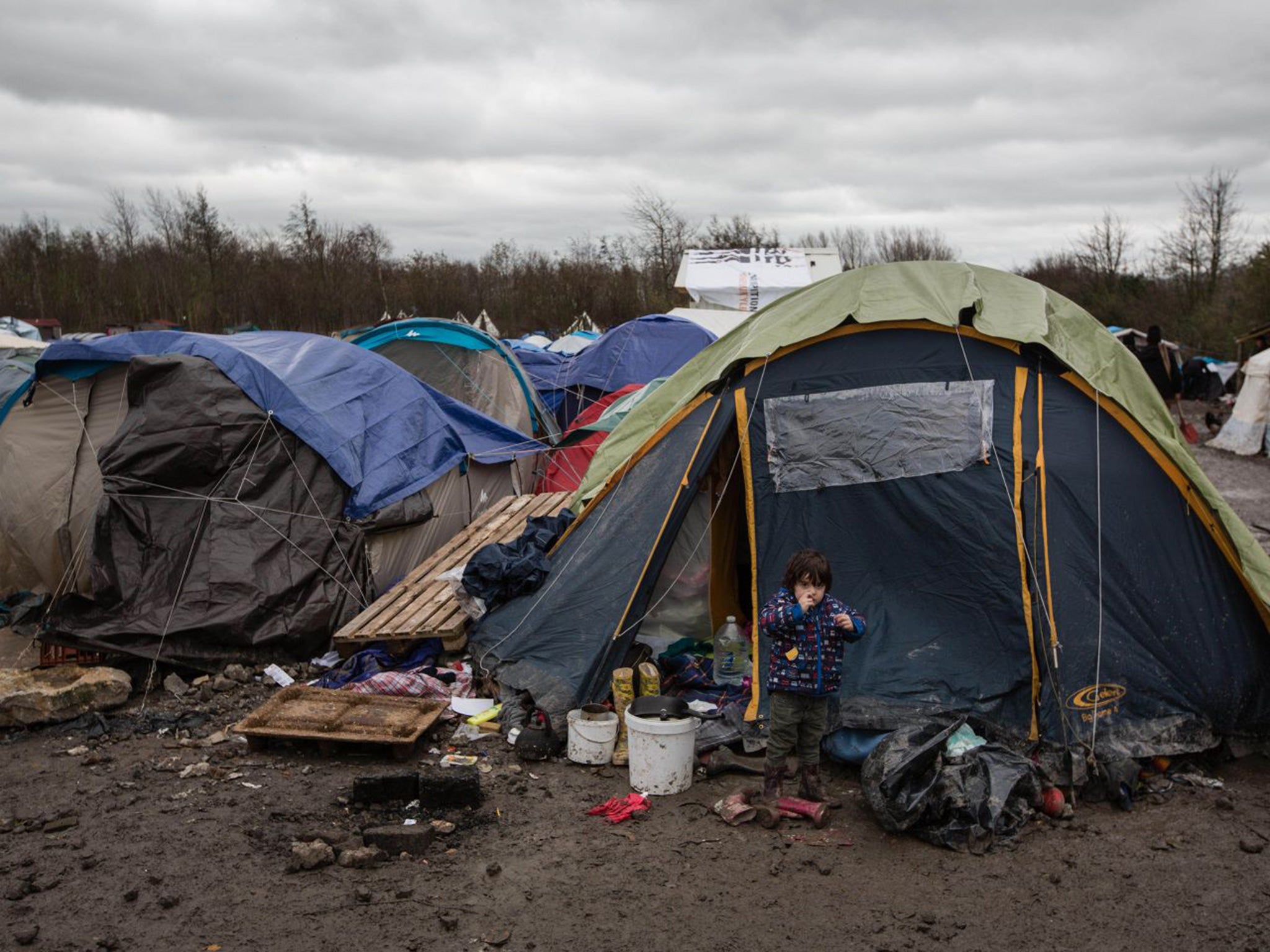 Mohammad Faiq, four, plays outside his family’s tent at the Grande-Synthe camp, near Dunkirk, yesterday