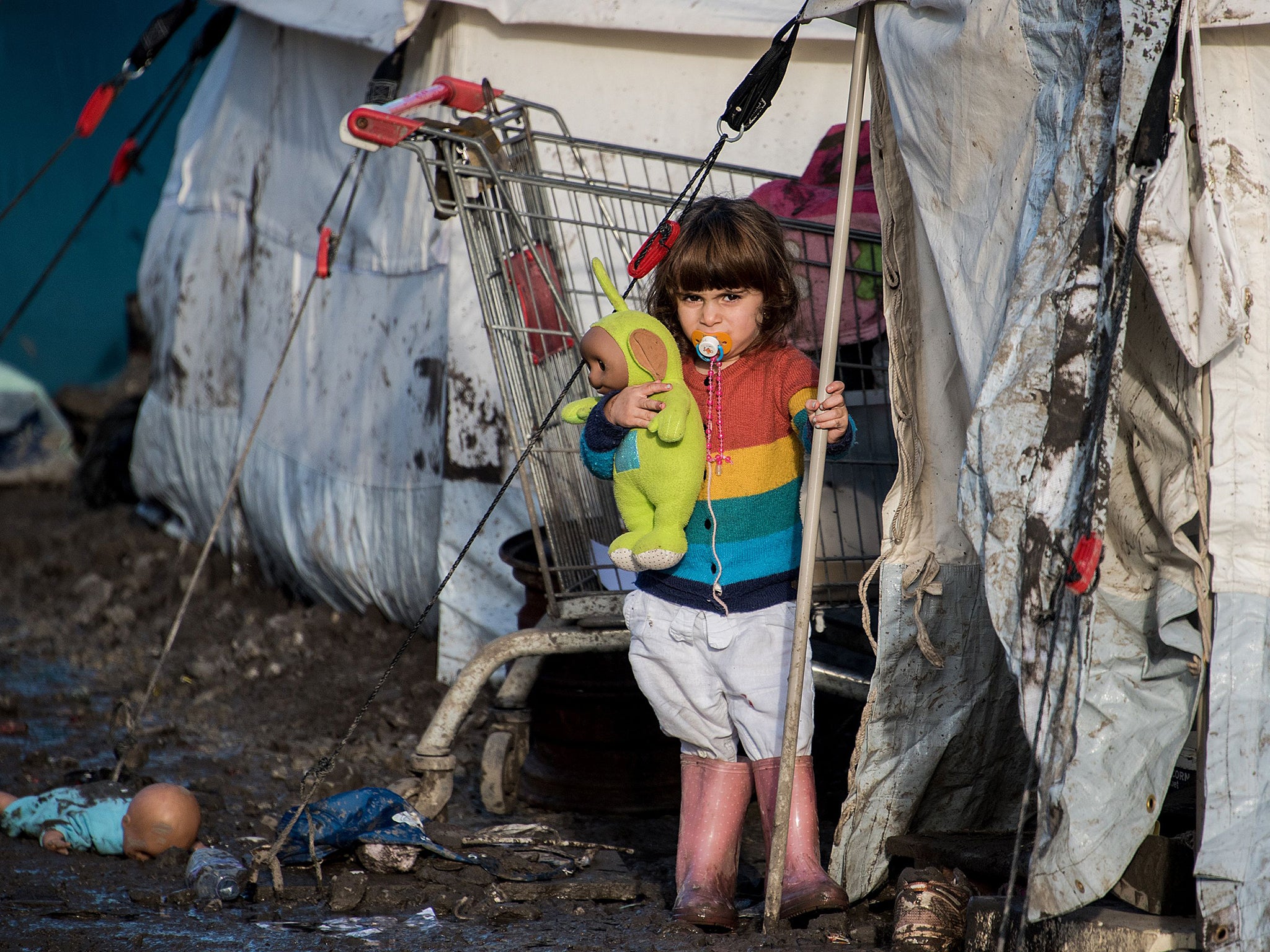 The child of Kurdish migrants stands outside a tent at the Grande Synthe migrant camp near Dunkerque in northern France. More than 2,000 migrants, mostly Iraqis and Kurds, live in the camp. The UN refugee agency and the International Organization for Migration (IOM) said this week more than one million migrants and refugees reached Europe this year, most of them by sea, more than four times the figure for 2014