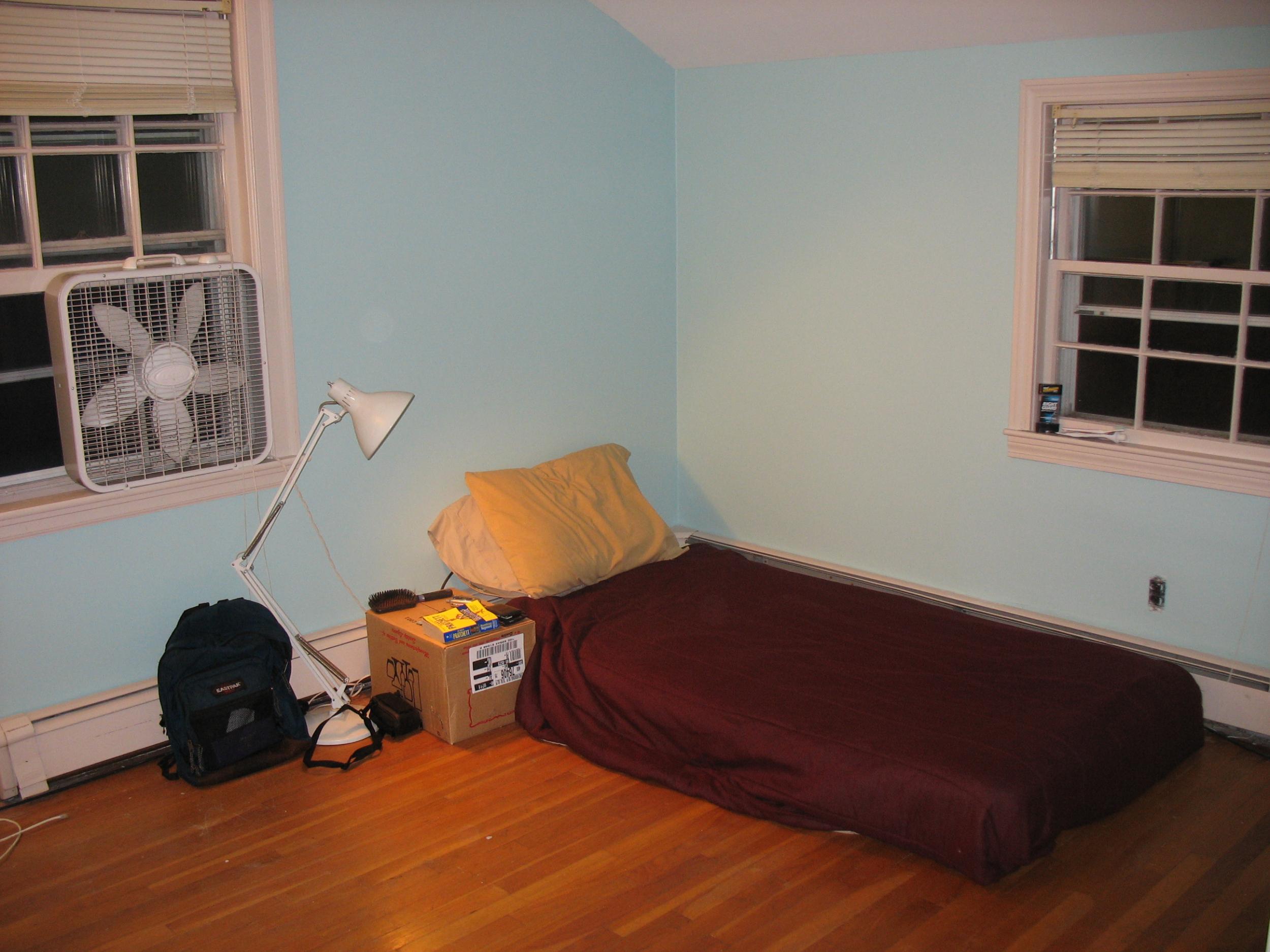 Mattress on the floor with cardboard sidetable