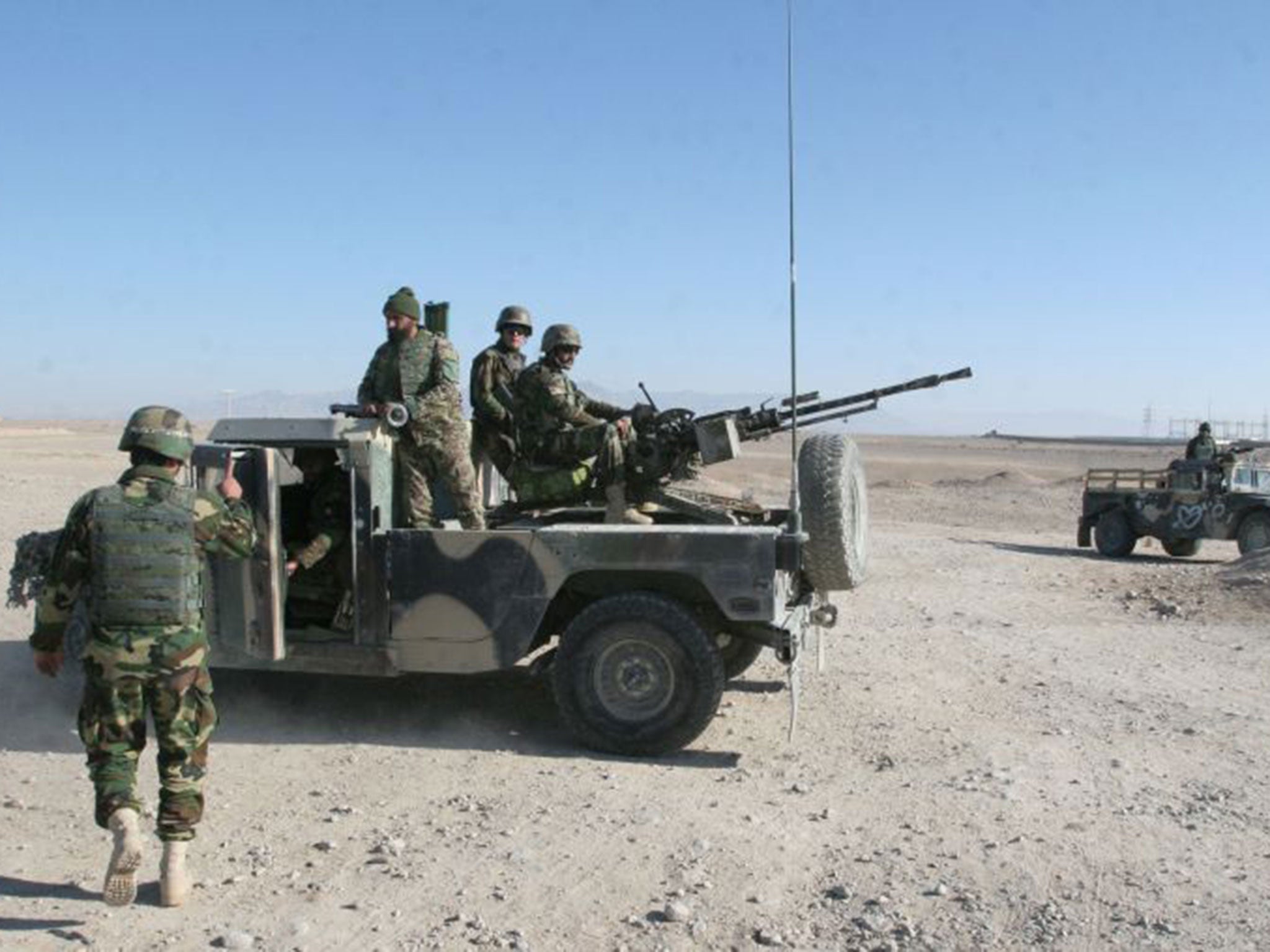 Afghan National Army soldiers guarding a checkpoint on the way to the Sangin. Government forces have been trying to recapture the area from the Taliban, who claim control of the district (PA)