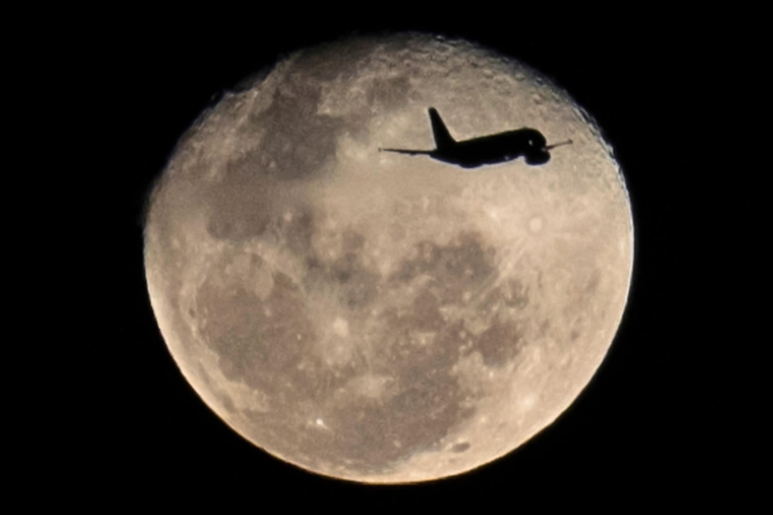 The full moon rises over Rio de Janeiro in Brazil