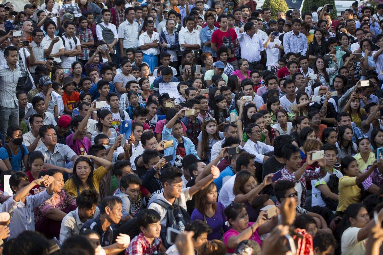 Demonstrators in Burma's largest city Rangoon protest against the Thai police investigation into the death of two British backpackers