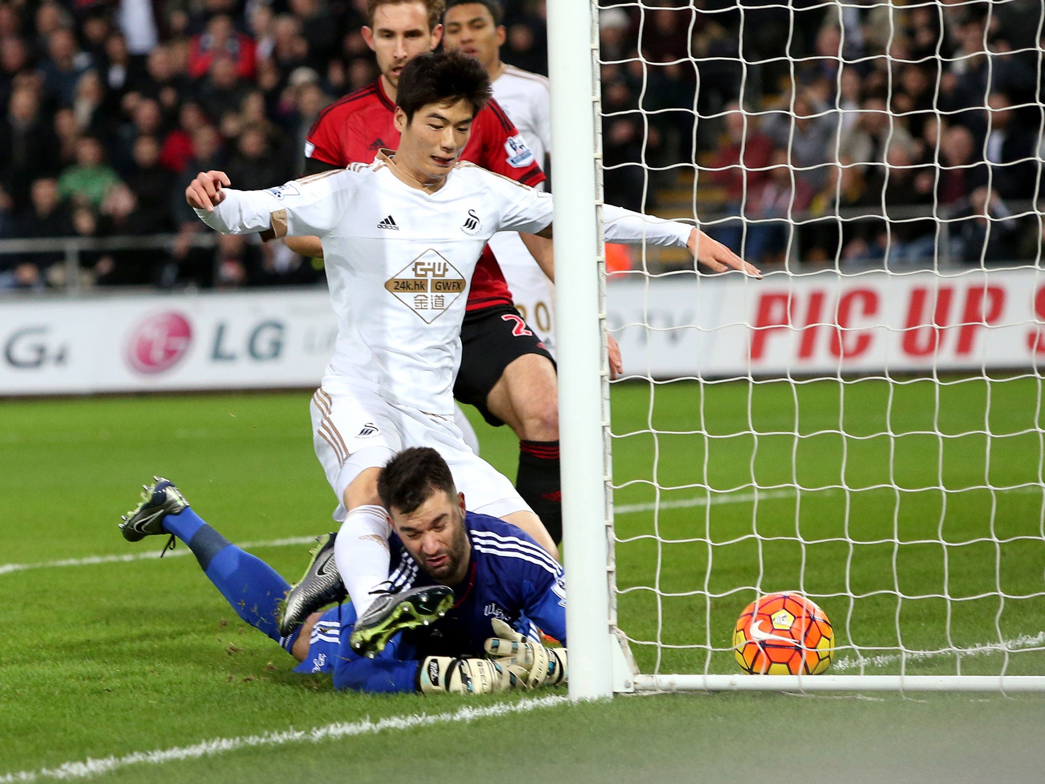 Ki Sung-yeung forces the ball over the line to give Swansea the lead against West Brom