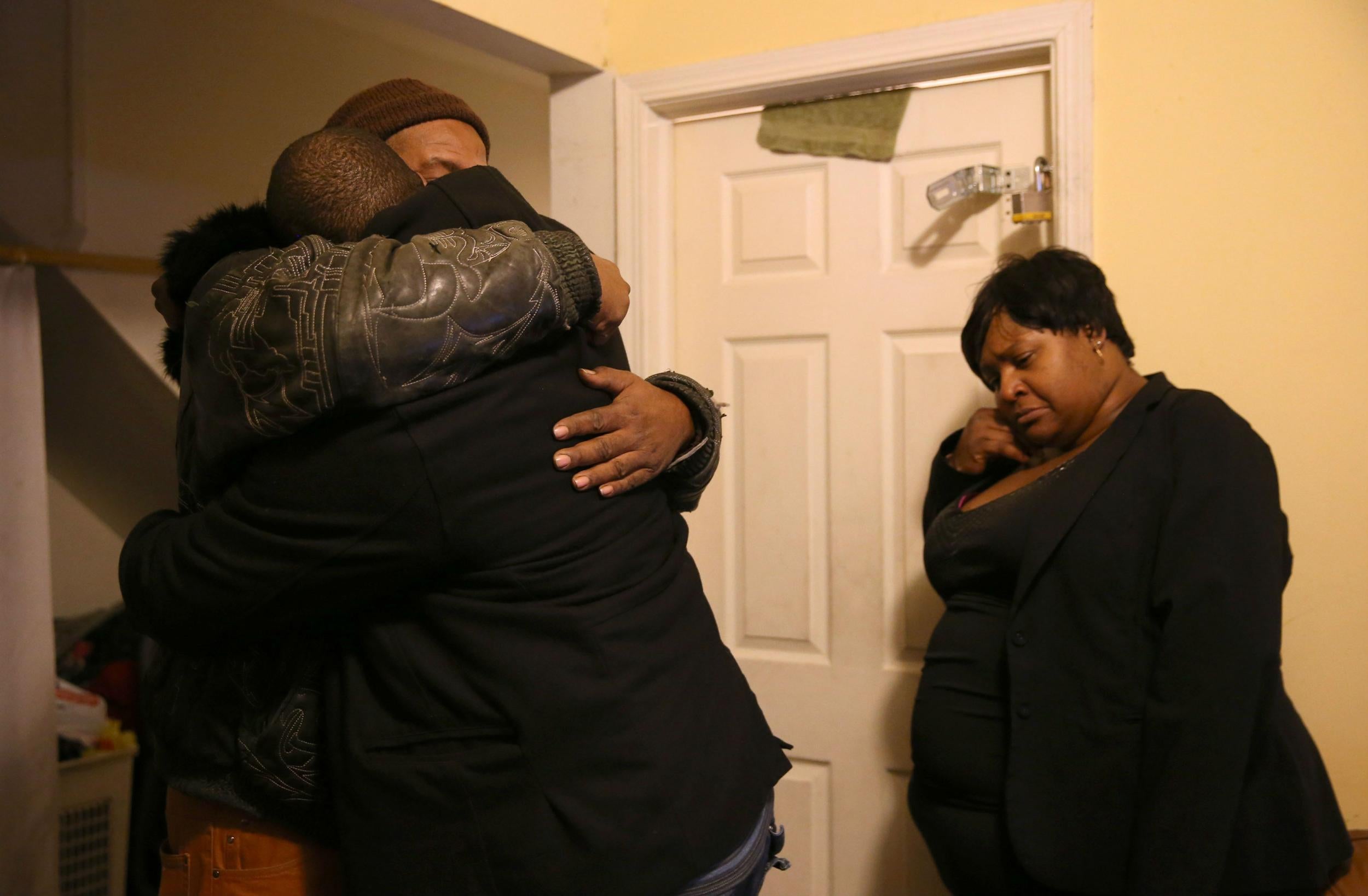 Bettie Jones' brother, Melvin Jones, hugs family members