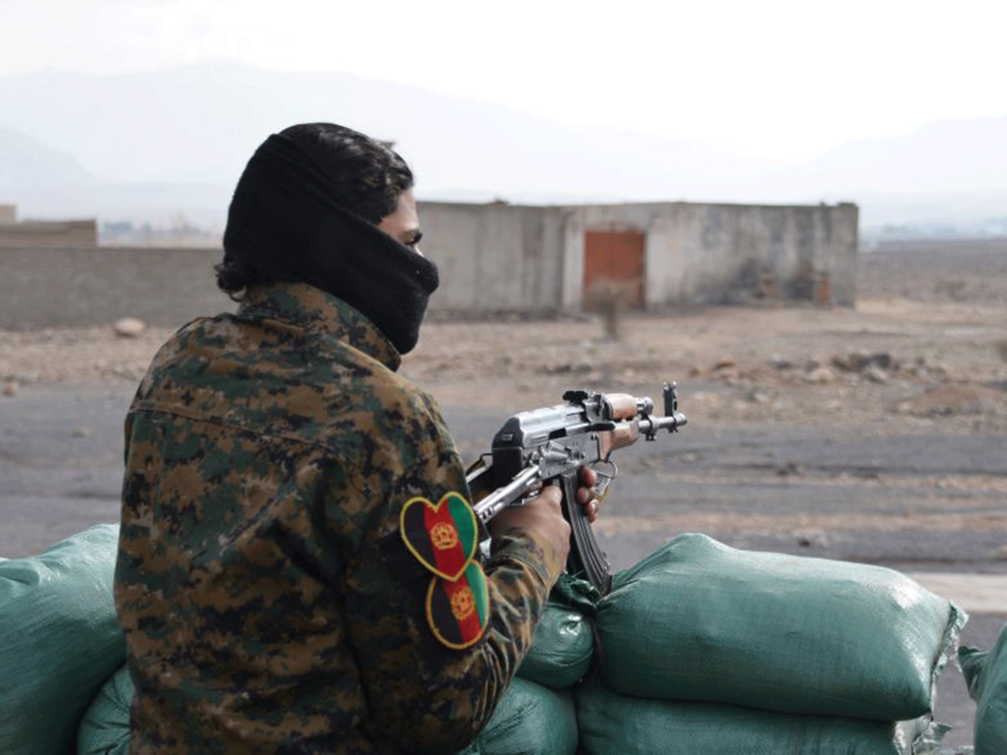 An Afghan militia man stands guard in the Achin district of Nangarhar province east of Kabul, Afghanistan, Sunday, Dec. 27, 2015.