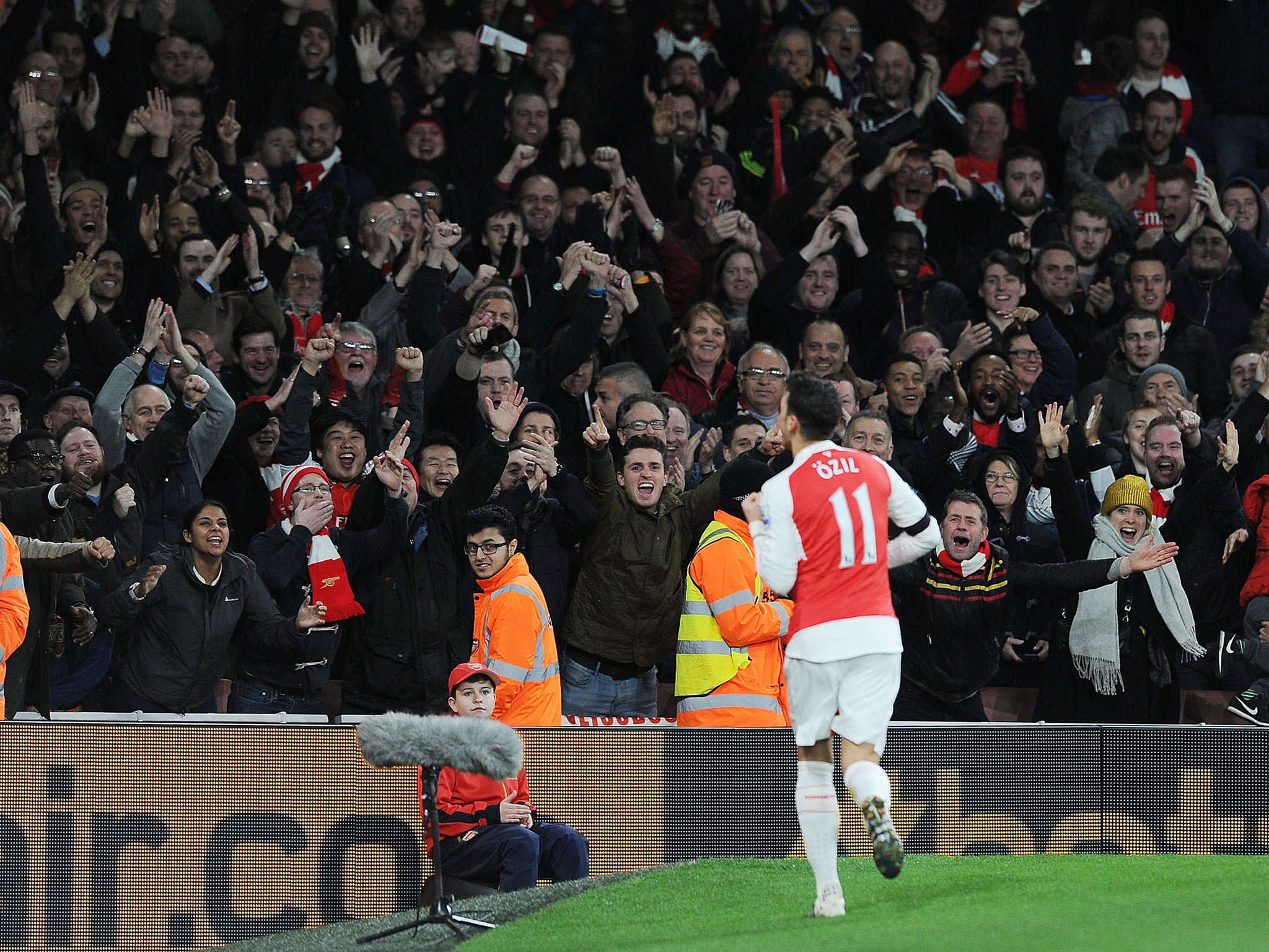 Mesut Ozil celebrates his goal in front of the Arsenal faithful