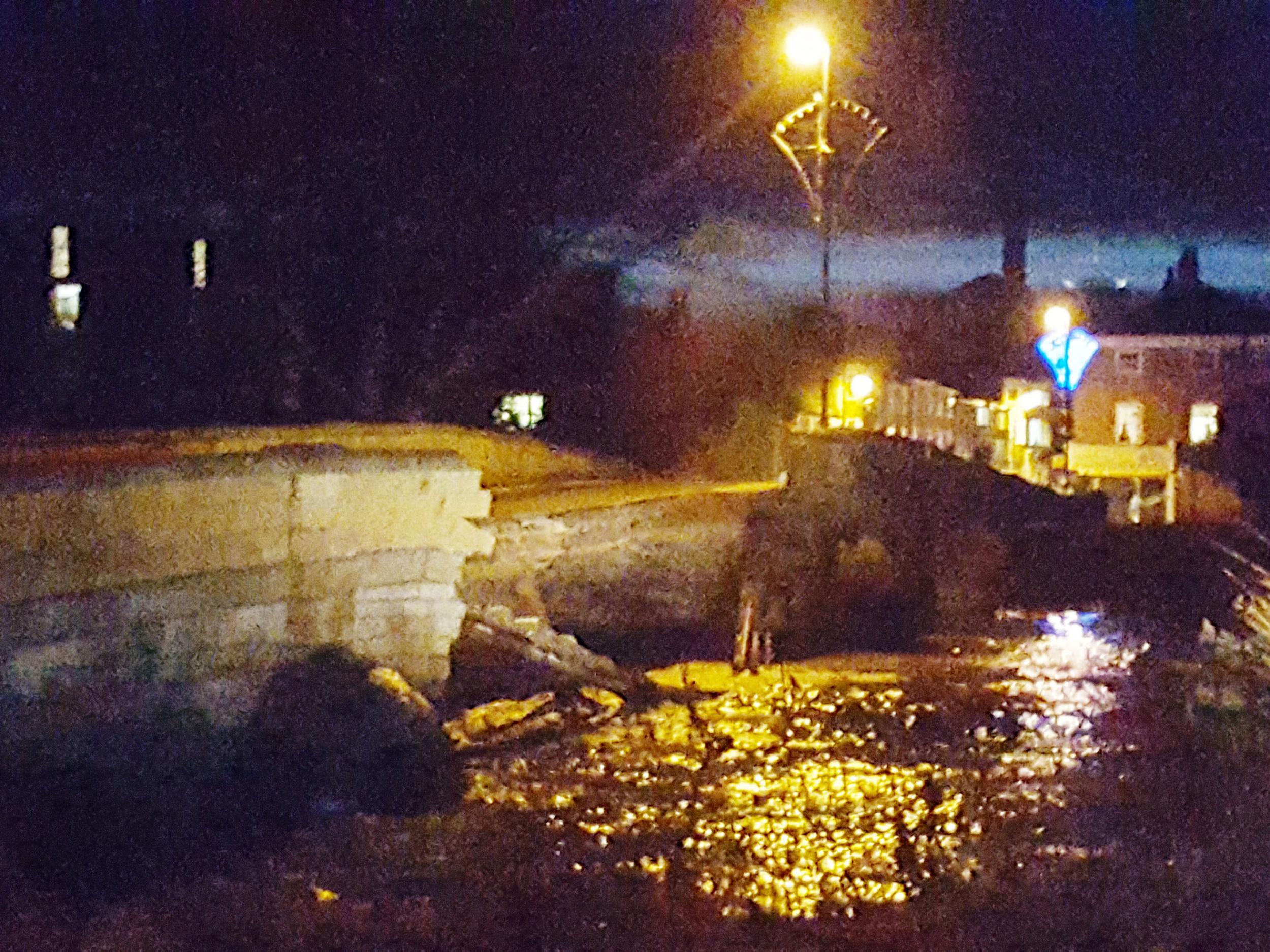 Part of the bridge has collapsed into the swollen River Wharfe running beneath it, exposing gas pipes