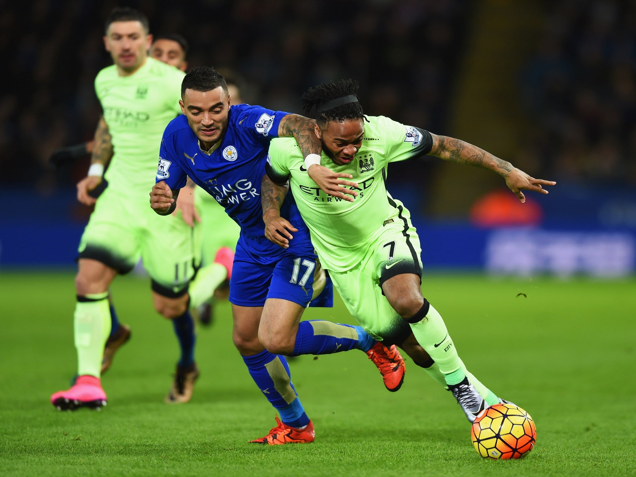 Danny Simpson jostles for the ball with Raheem Sterling