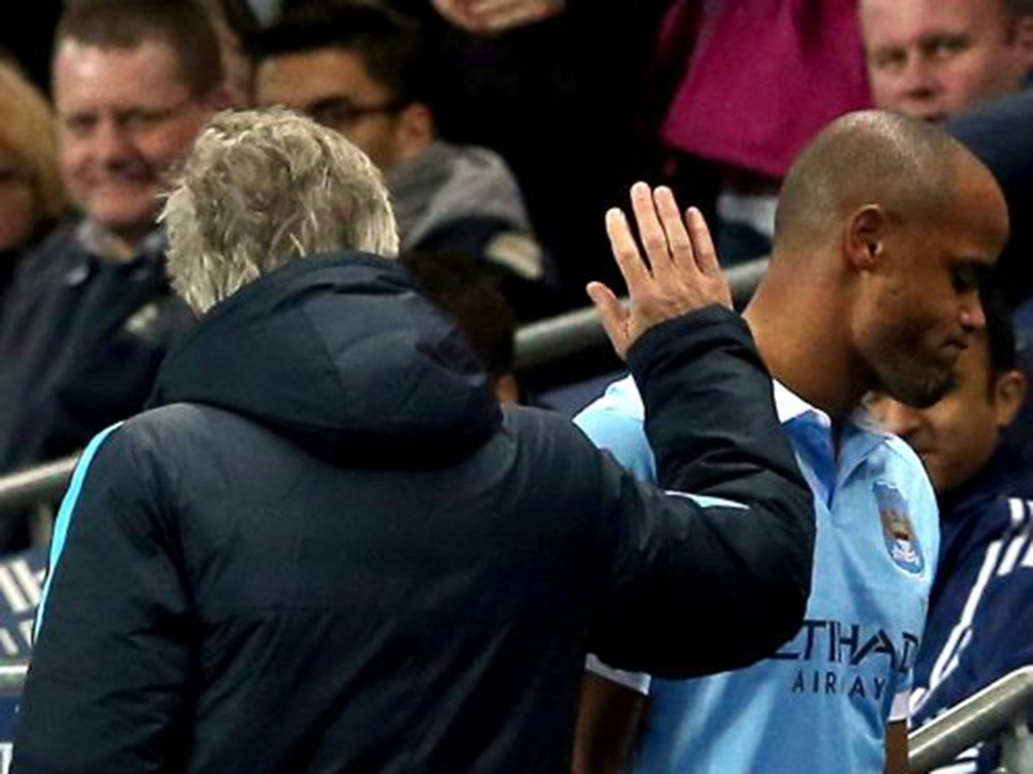 Vincent Kompany walks off injured past manager Manuel Pellegrini after a recurrence of a calf injury against Sunderland