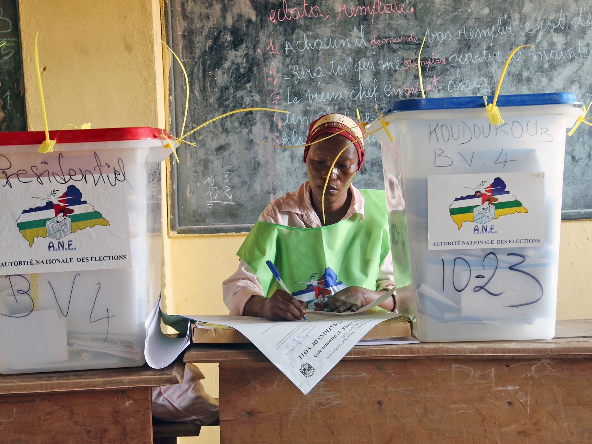 A election official writes as people cast their ballots. Many voters will hope that a new president will lead to greater stability after years of violence