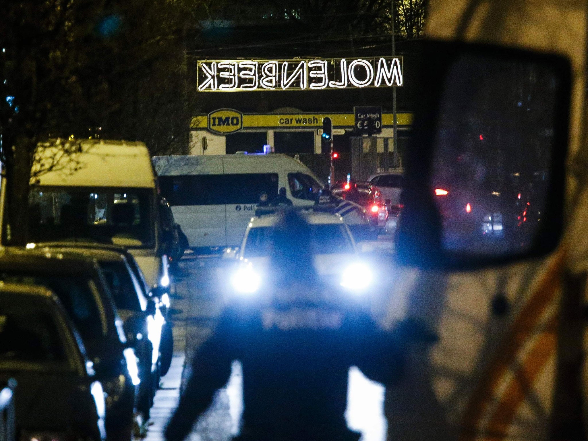 Police officers are pictured as police conduct new searches linked to the November 13 Paris terrorist attacks, on December 30, 2015, in Molenbeek, Brussels.