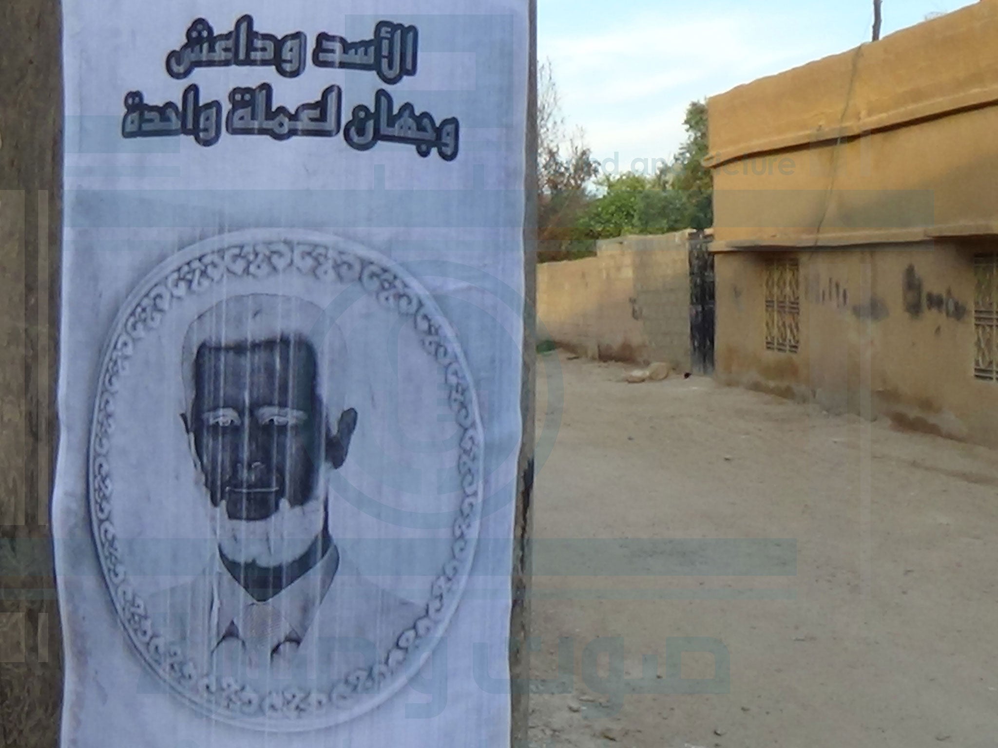 This poster in Raqqa reads: ‘Assad and Isis are two sides of the same coin'