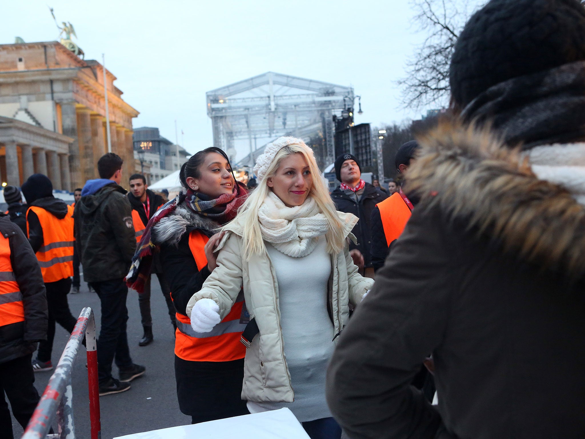 Officers inspect revellers at the Brandenburg Gate in Berlin