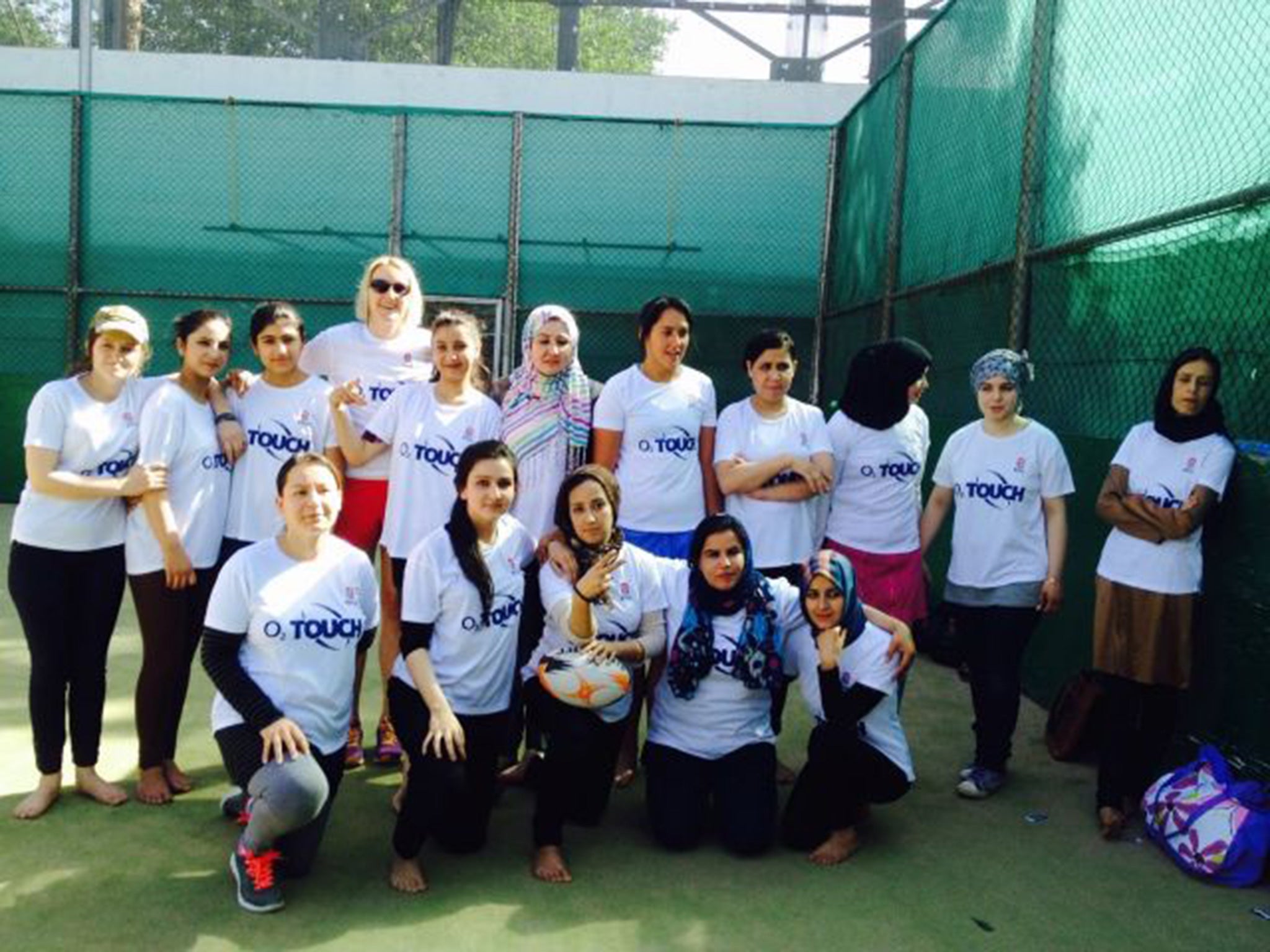 The squad play barefoot on the tennis court of the British embassy in Kabul