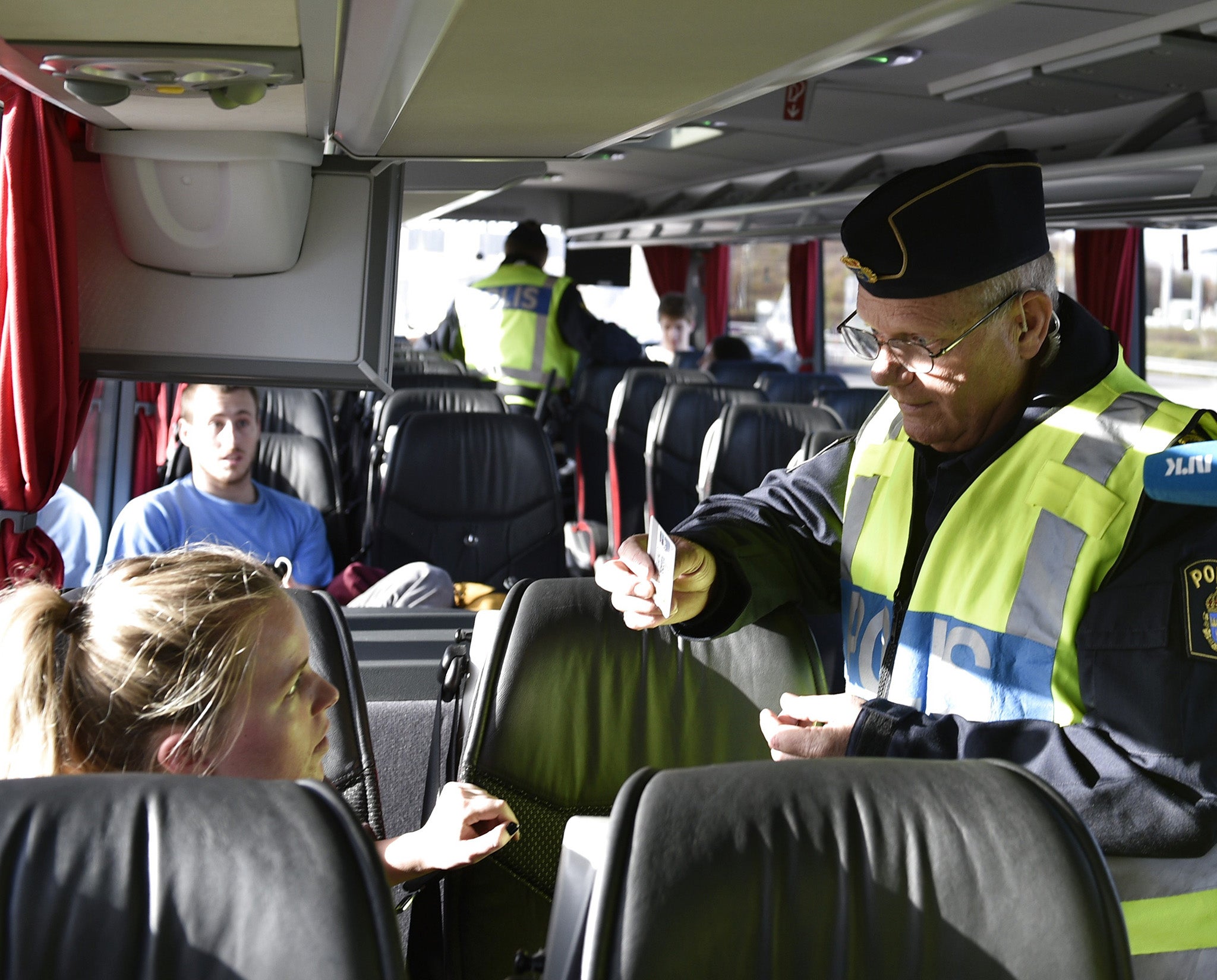 A Swedish border guard checking documents