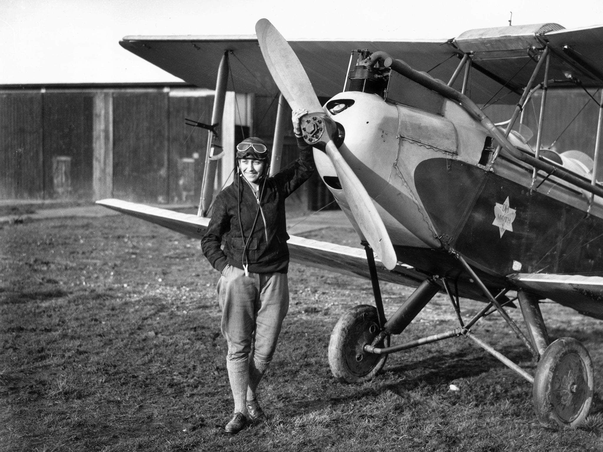 English aviator Amy Johnson standing in front of her Gipsy Moth just before she undertook a 19-day solo flight to Australia. She died in 1941 when an aircraft she was ferrying crashed into the Thames estuary.