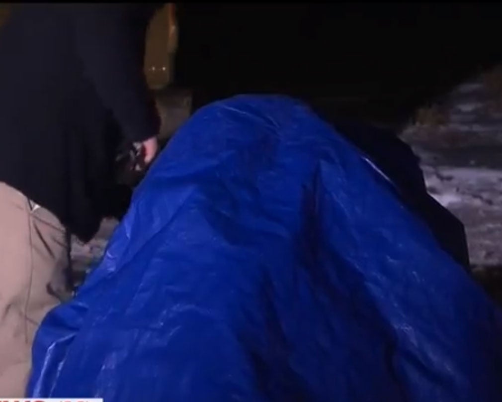 Lavoy Finicum, 55, retreats under his tarp while protesting at a refuge in Oregon