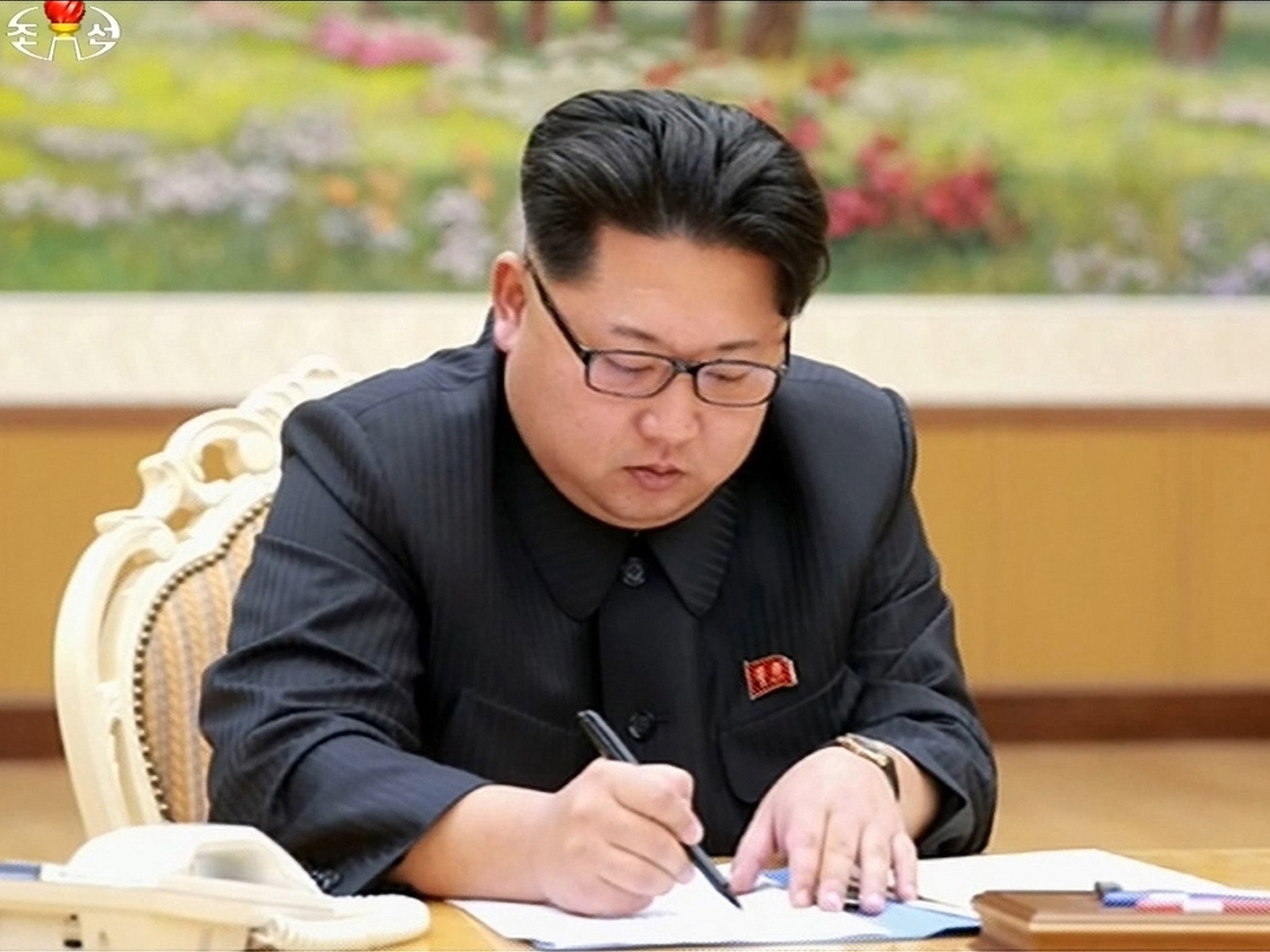 Kim Jong-un, purportedly as he signs approval of an H-bomb test in North Korea