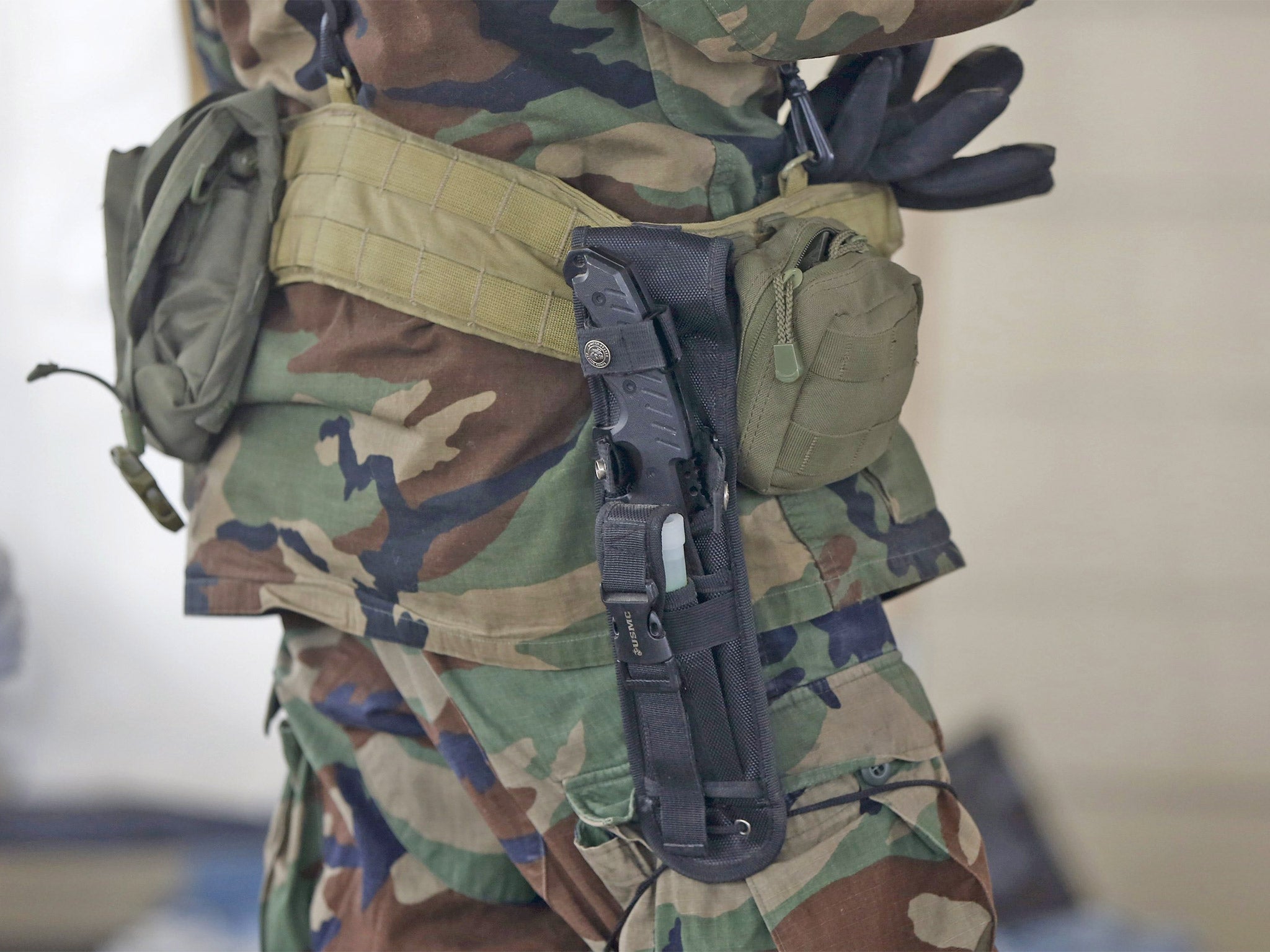 A militiaman carries a knife at the Malheur National Wildlife Refuge