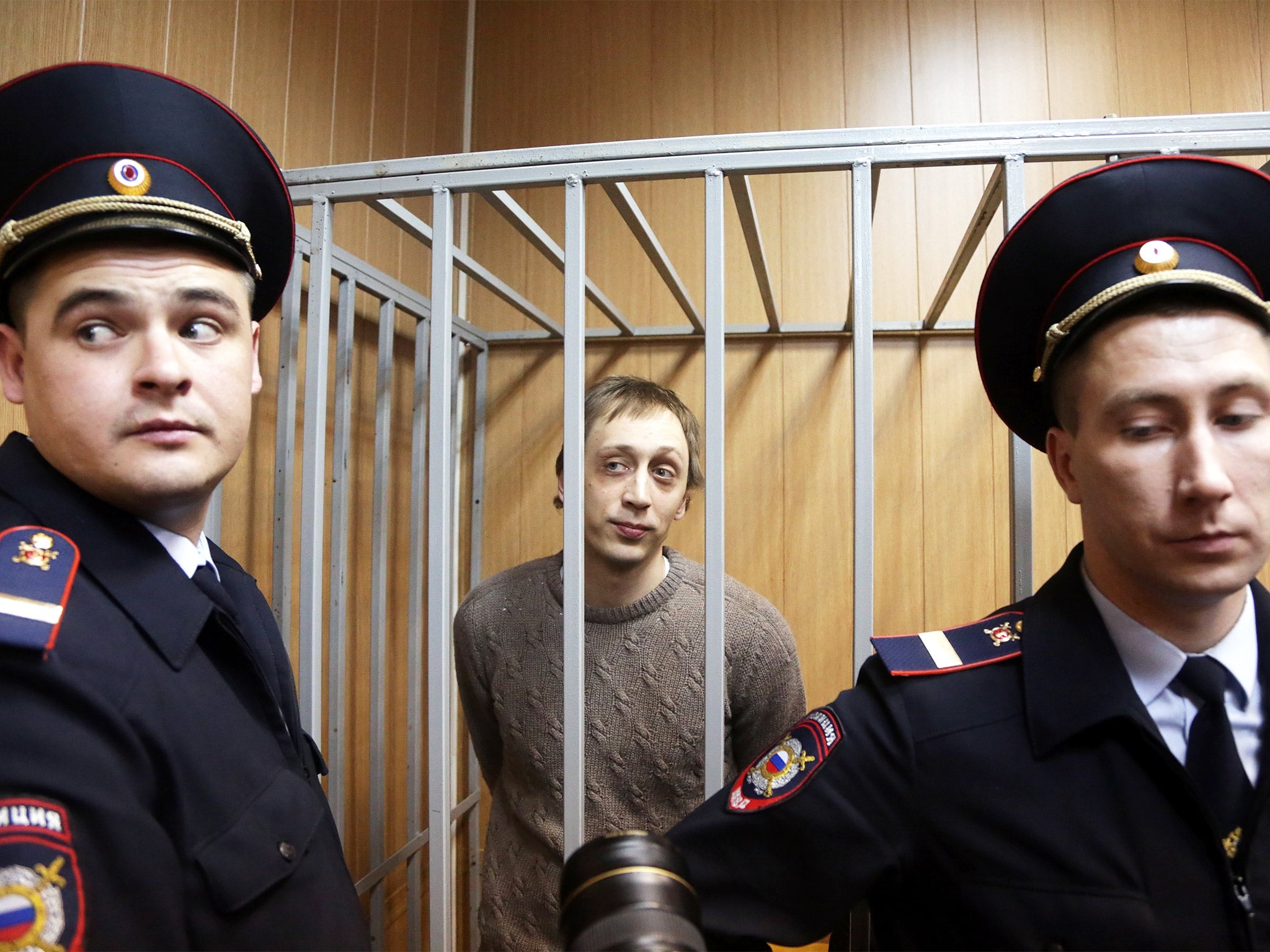 Pavel Dmitrichenko in the defendant's cage during a 2013 court hearing in Moscow