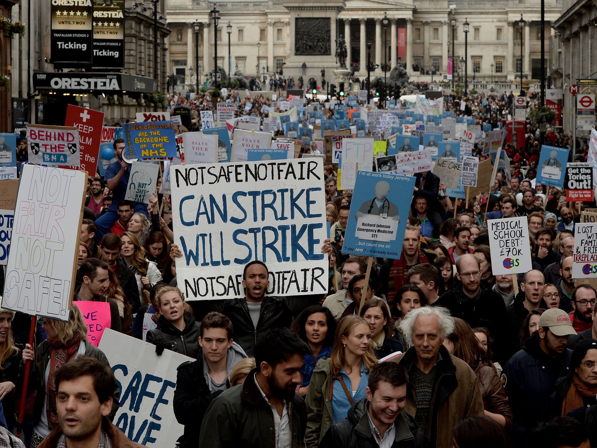 Demonstrators march down Whitehall during the 'Let's Save the NHS' rally and protest march by junior doctors in London