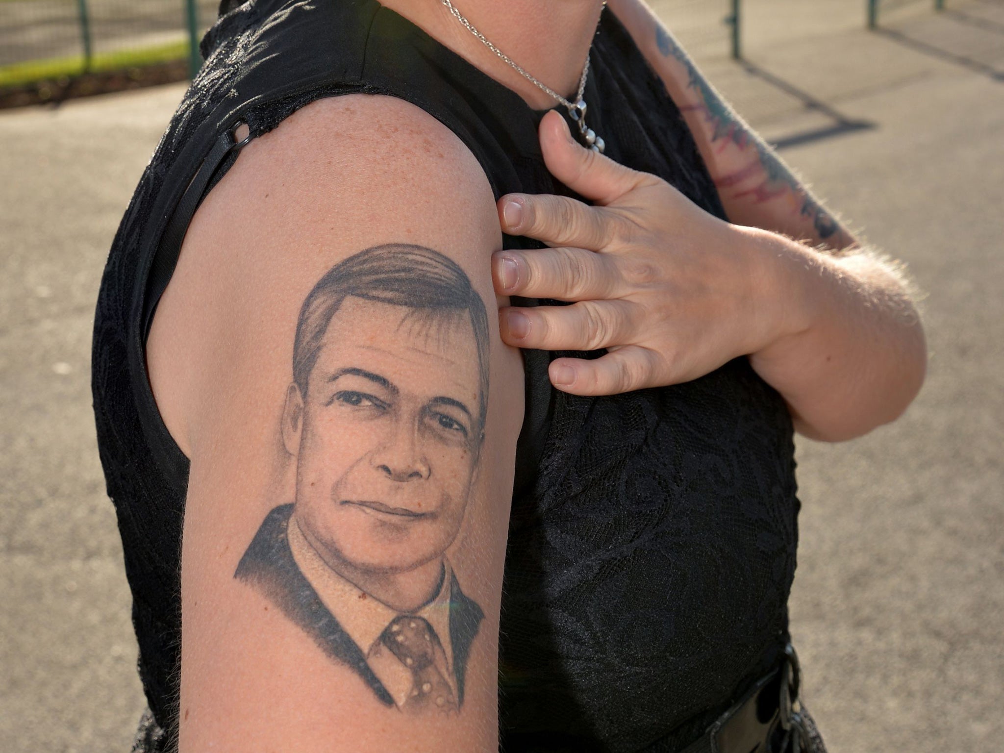 Ukip party supporter Kerrie Webb displays her Nigel Farage tattoo during the Ukip Annual Conference at Doncaster Racecourse