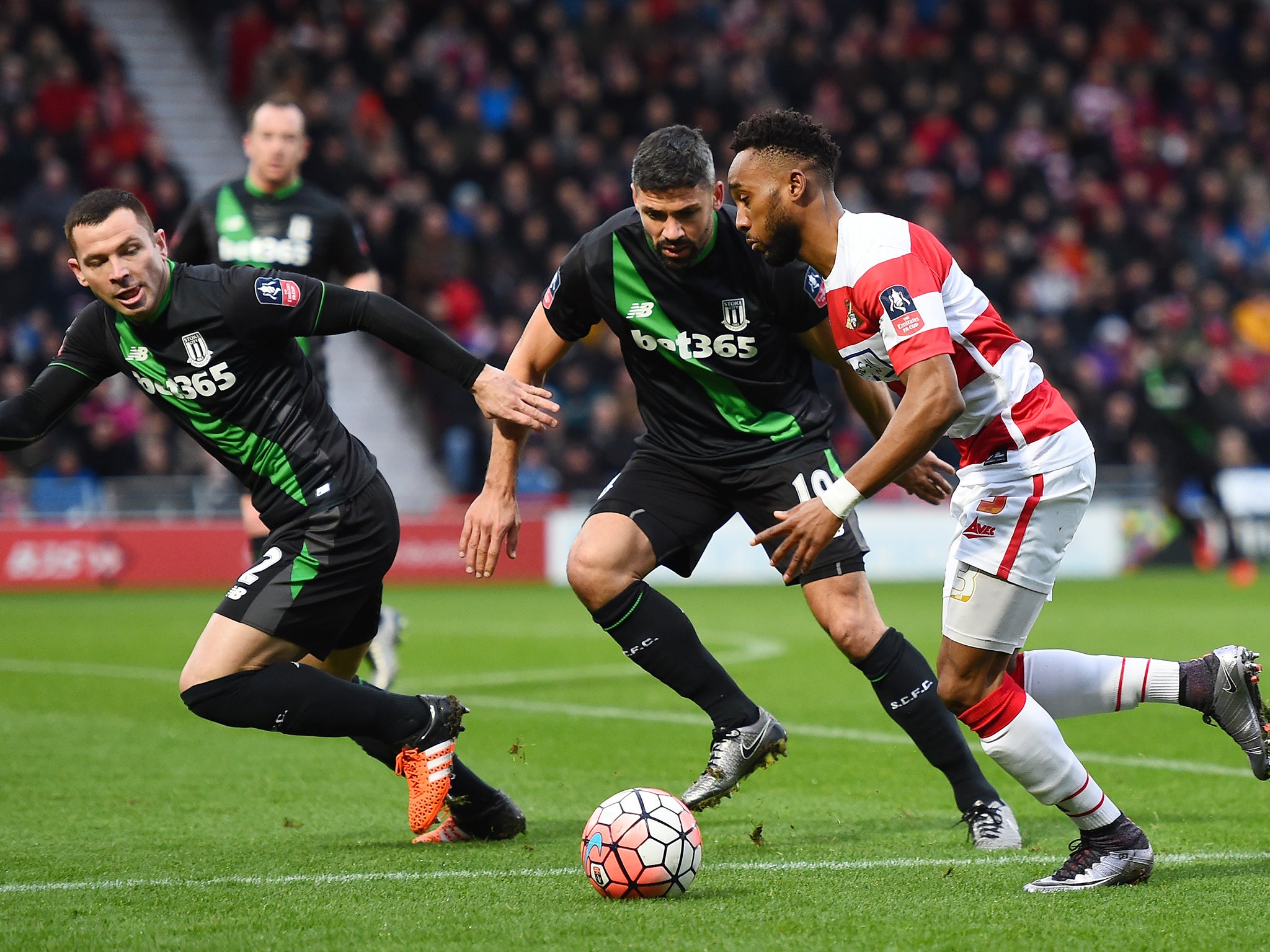 Doncaster Rovers' Nathan Tyson takes on Jonathan Walters and Phil Bardsley