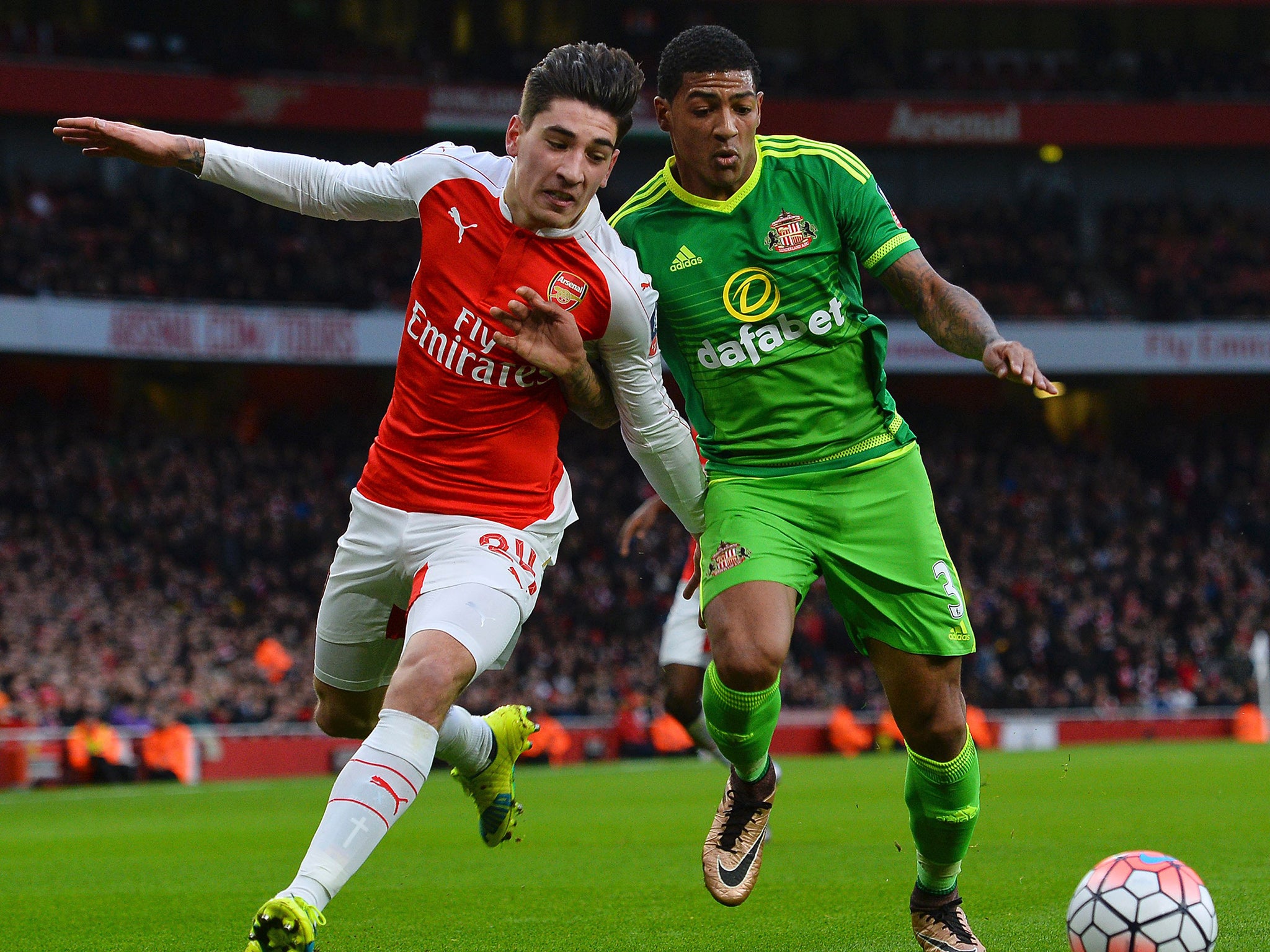 Hector Bellerin challenges for the ball with Patrick van Aanholt