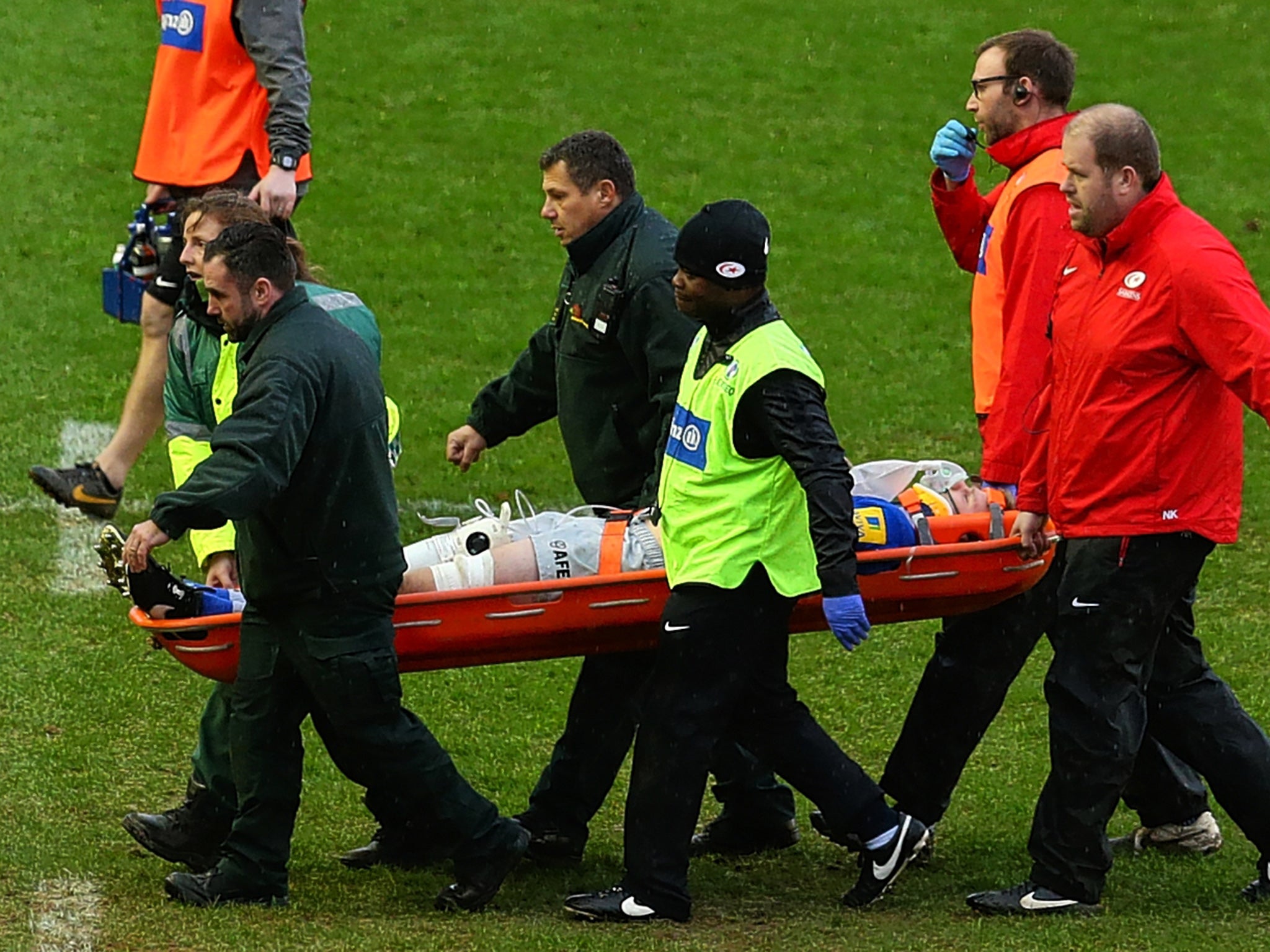 Saracens and England lock Geroge Kruis is stretchered off during yesterday's defeat to Harlequins with a suspected concussion