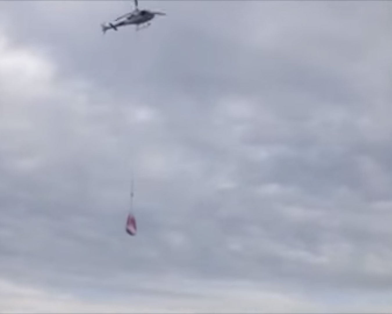 A helicopter is seen bringing fresh snow to the slope