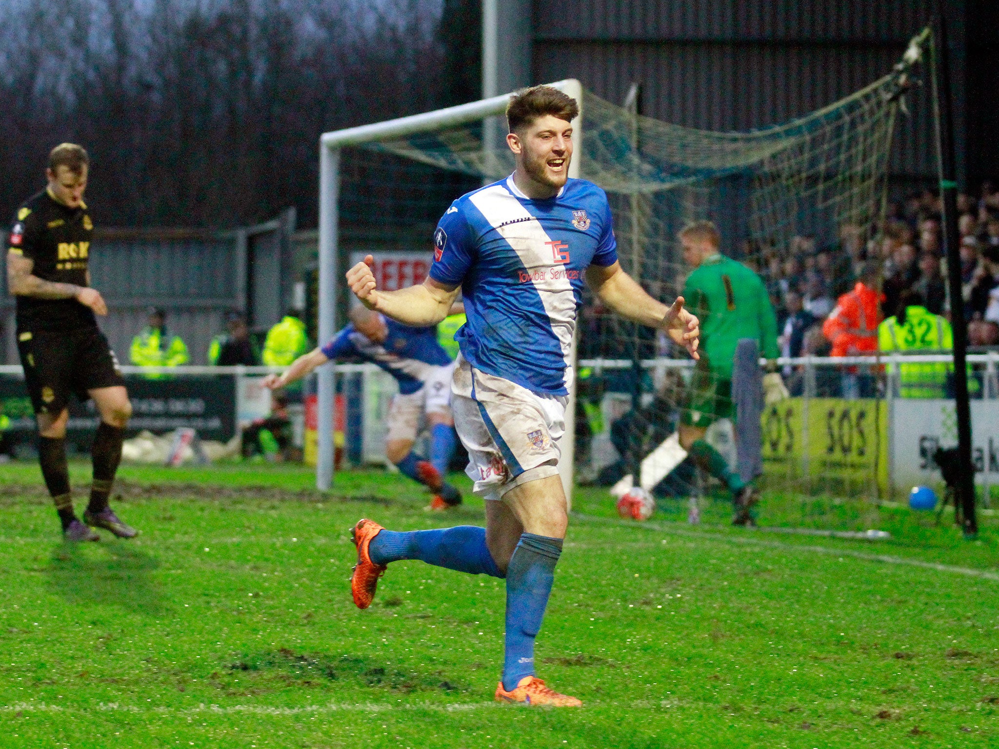 Eastleigh players celebrate after an own goal by Bolton’s Dorian Dervite