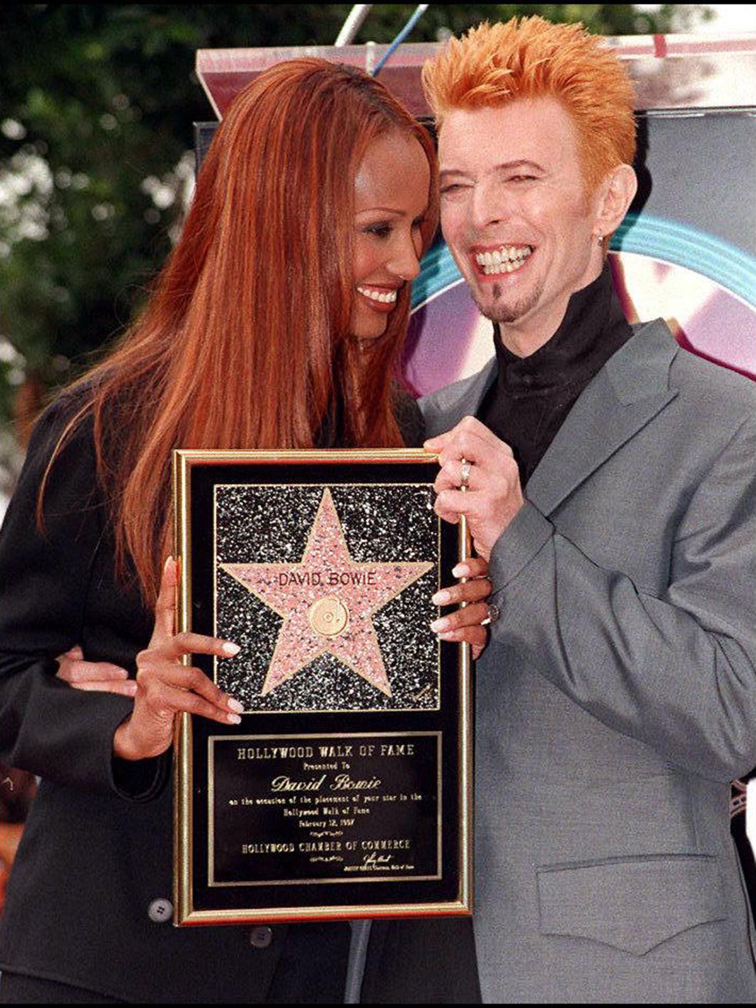 David Bowie and his wife, supermodel Iman smile as they pose for photos after Bowie received a star on the world famous Walk of Fame 12 February in Hollywood, 1997