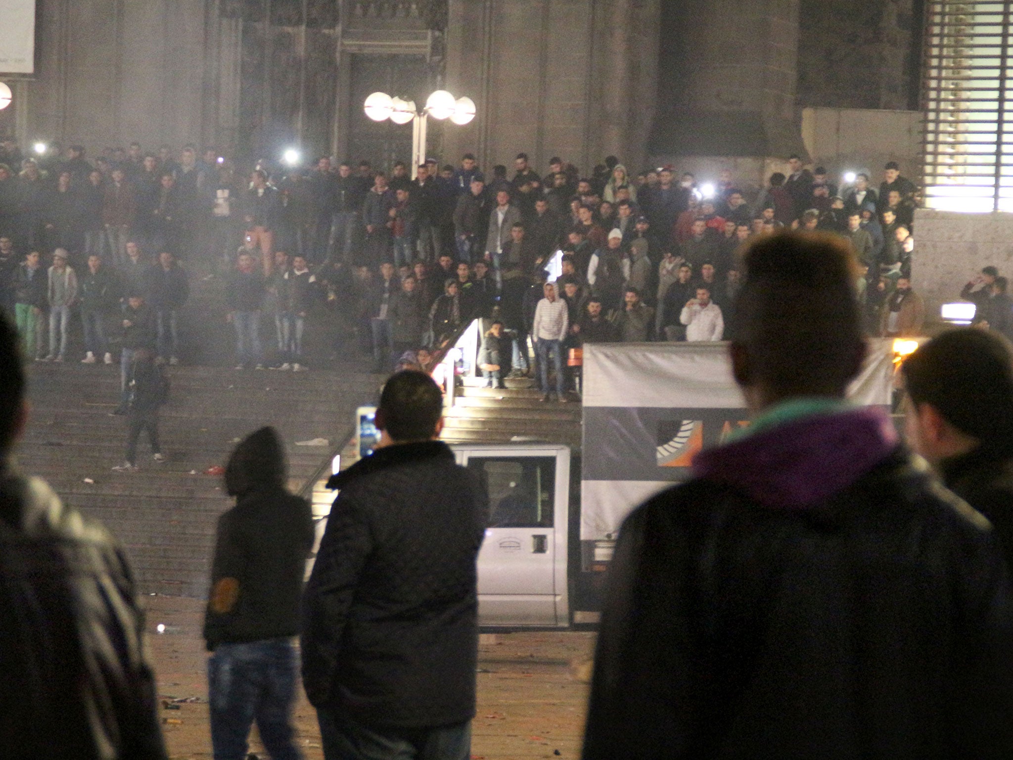 Picture taken on 31 December, 2015 shows people gathering in front of the main railway station in Cologne