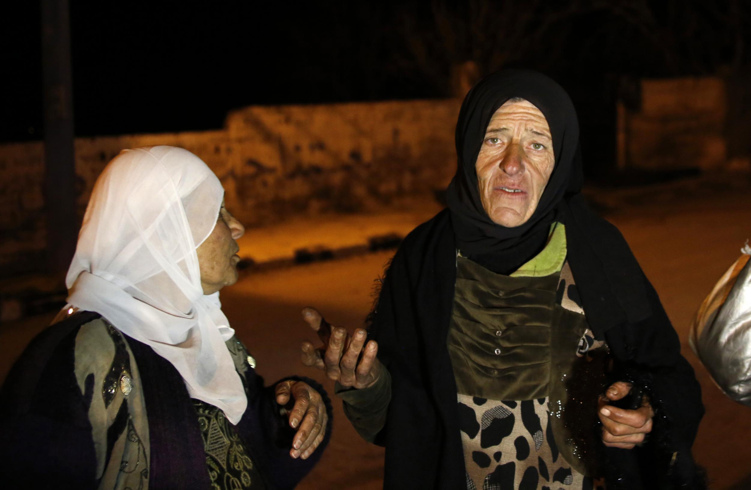 Residents talk to reporters in the besieged town of Madaya, northwest of Damascus, Syria