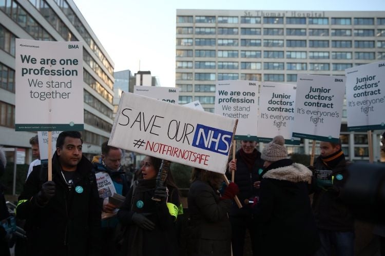 Members of staff take part in a picket outside St Thomas' Hospital on January 12, 2016 in London, United Kingdom.