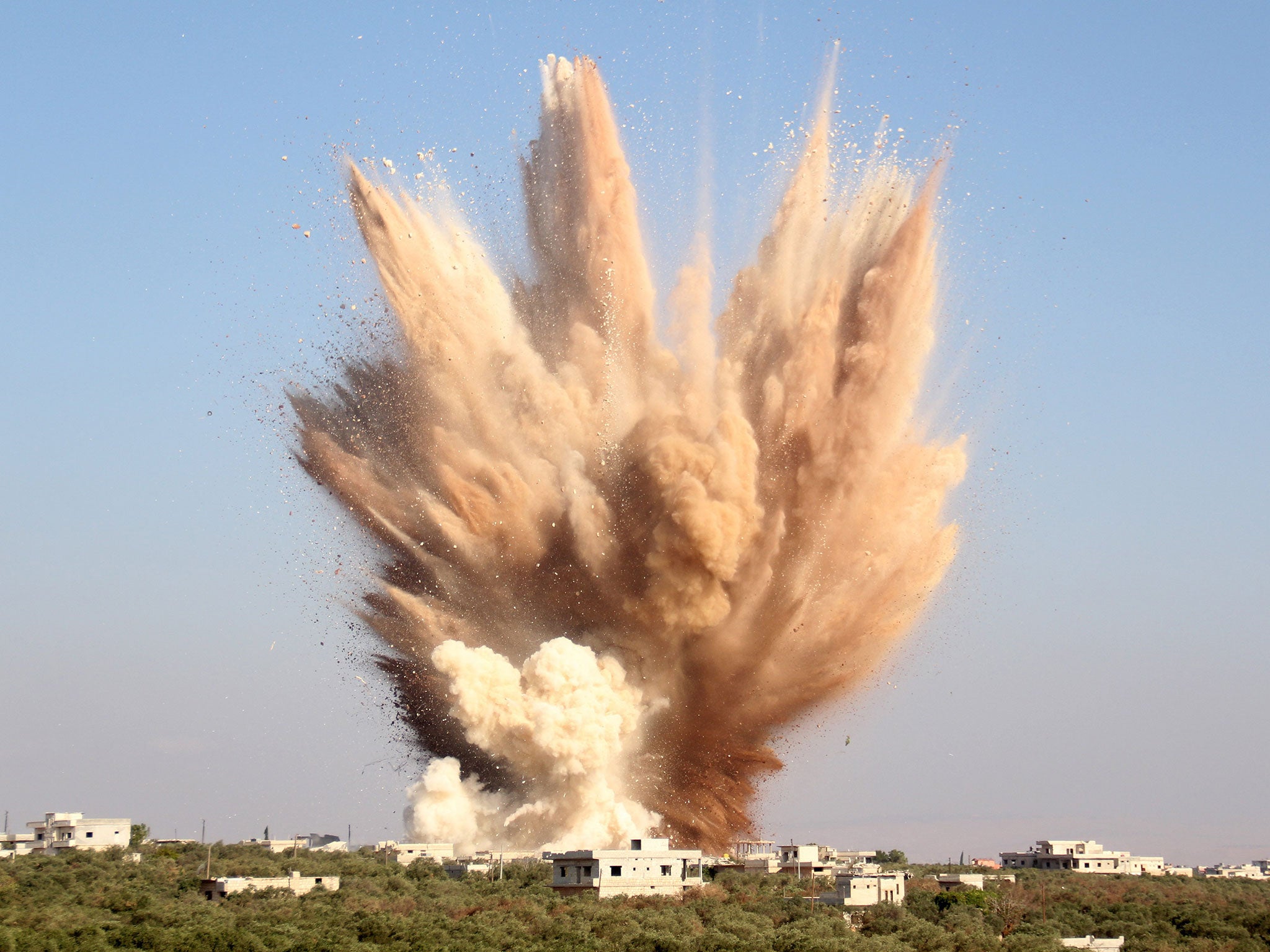 Smoke billowing following a reported attack on a tunnel used by forces loyal to President Bashar al-Assad in the village of Foua, in the northwestern province of Idlib, on August 10, 2015