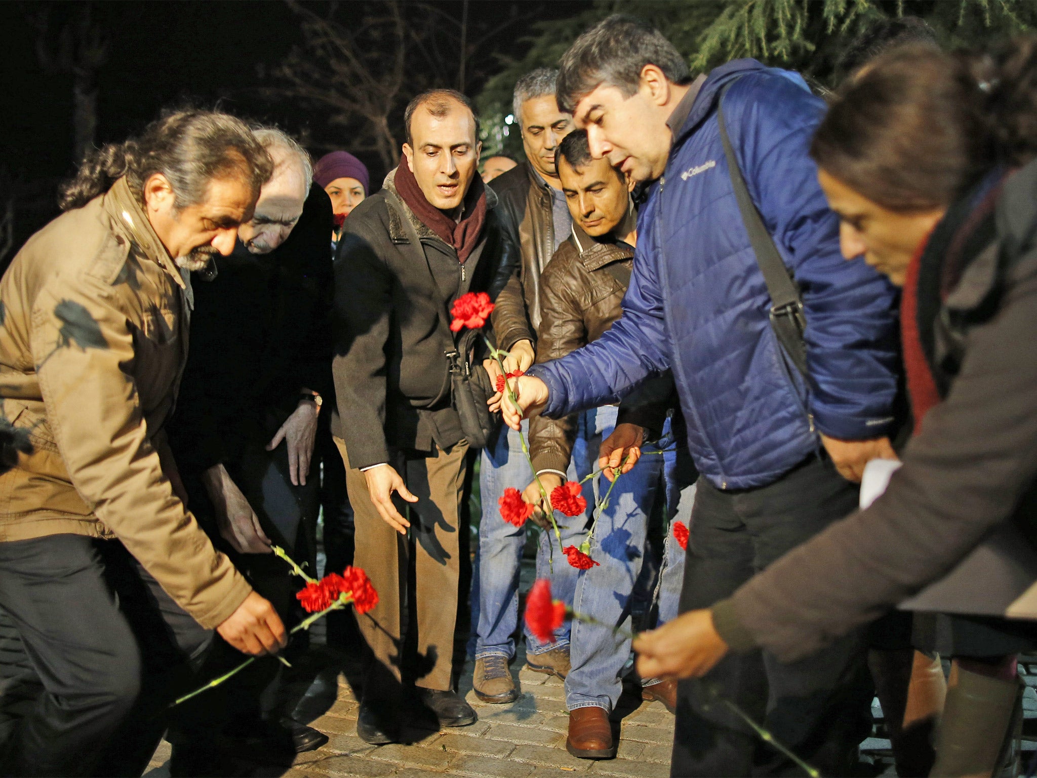 Citizens leave carnations near the site of the blast