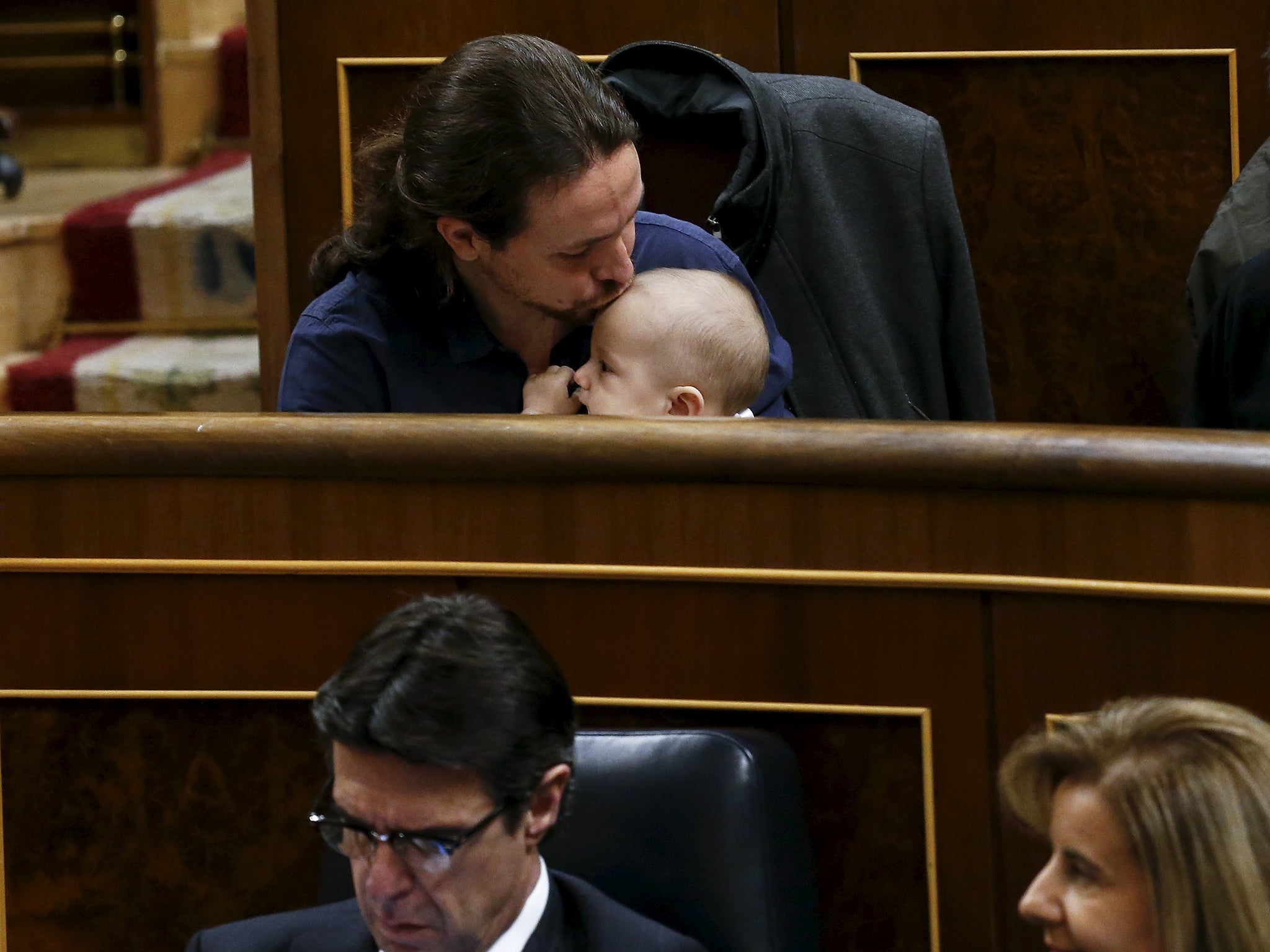 Podemos (We Can) party leader Pablo Iglesias kisses the infant son of fellow party deputy Carolina Bescansa (not pictured) as parliament convened for the first time following a general election in Madrid, Spain