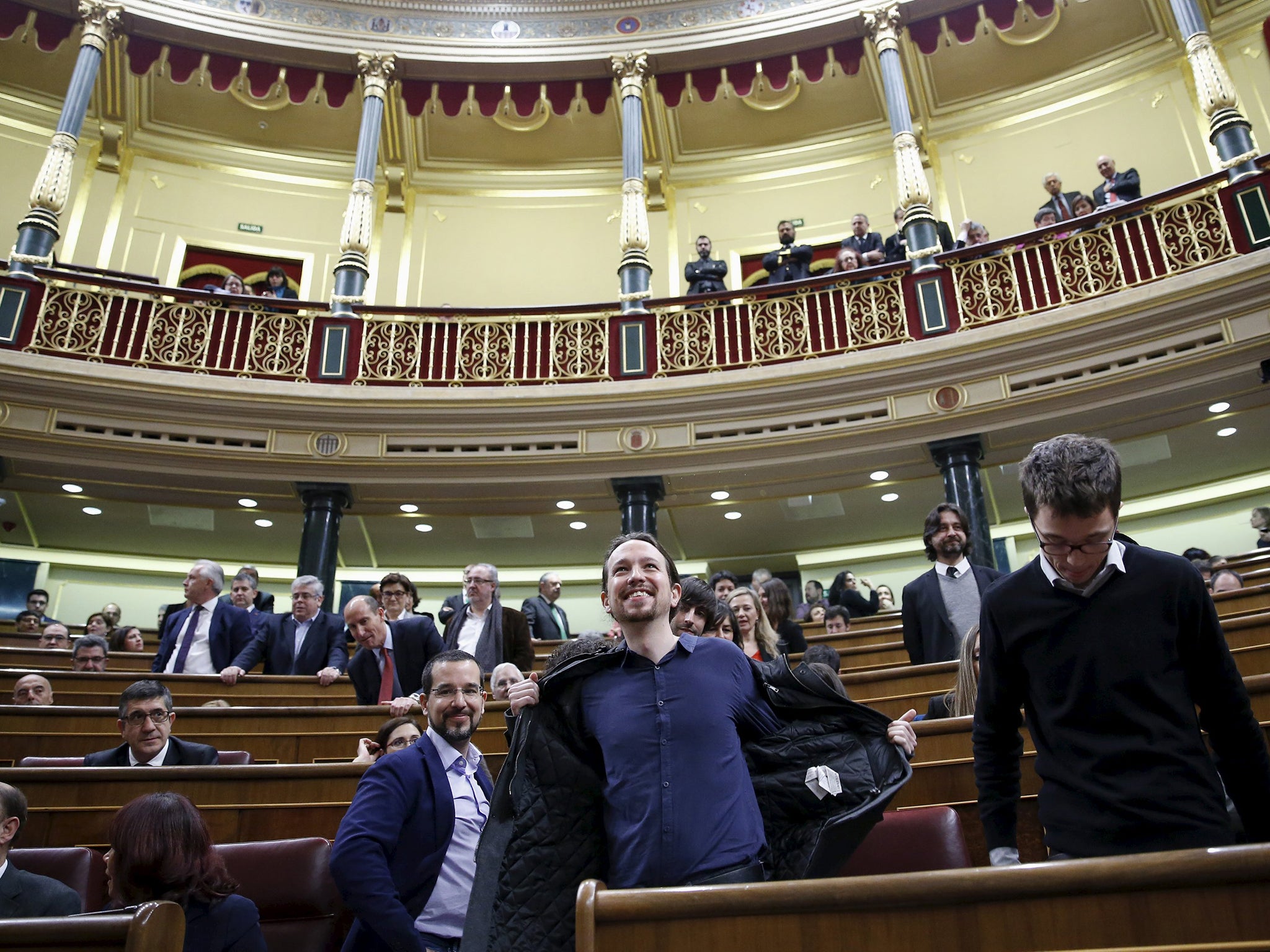 Pablo Iglesias takes off his jacket as members of parliament took their seats as parliament convened for the first time following a general election in Madrid Reuters