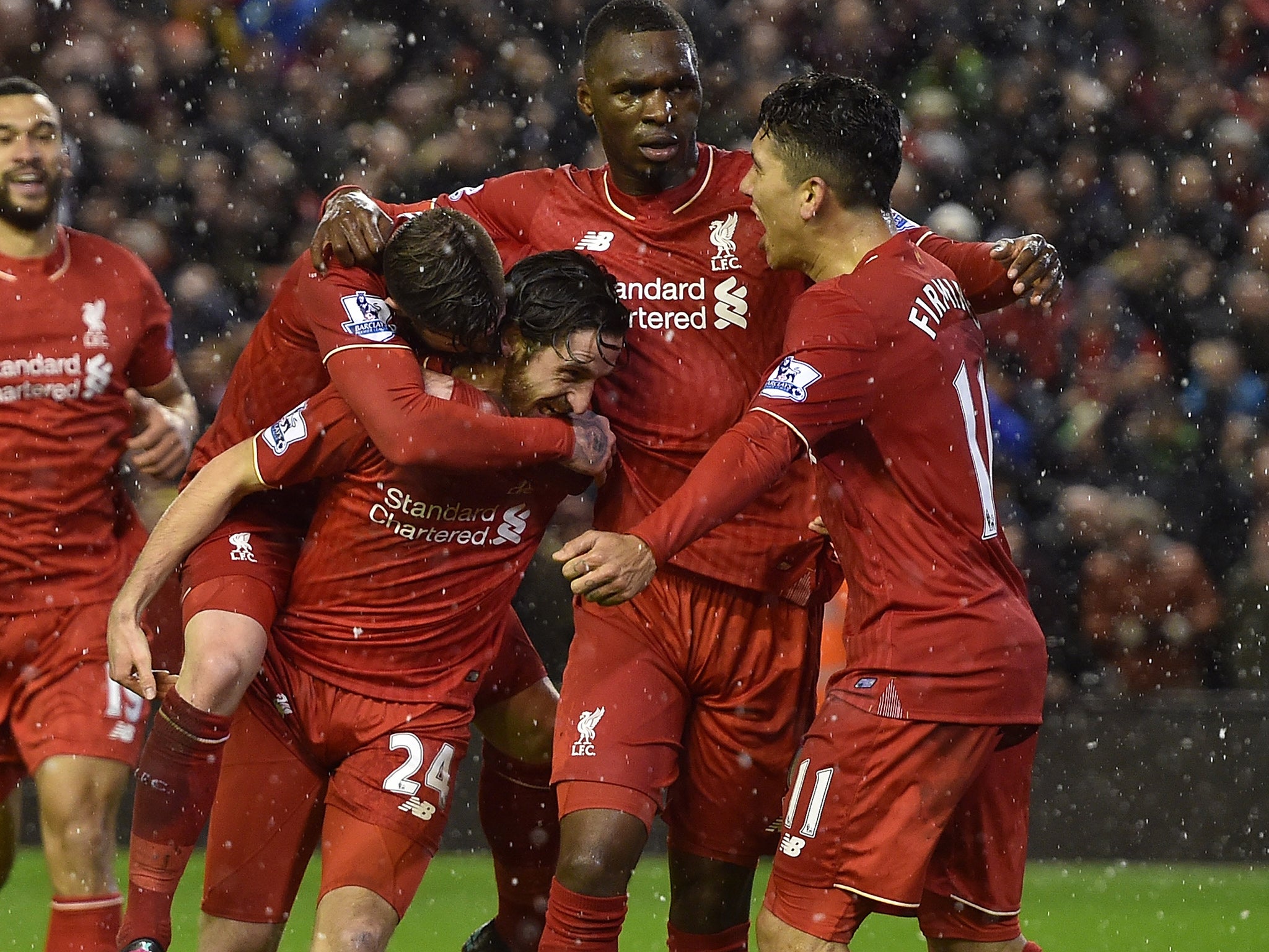 Liverpool players celebrate Joe Allen's (#24) winner