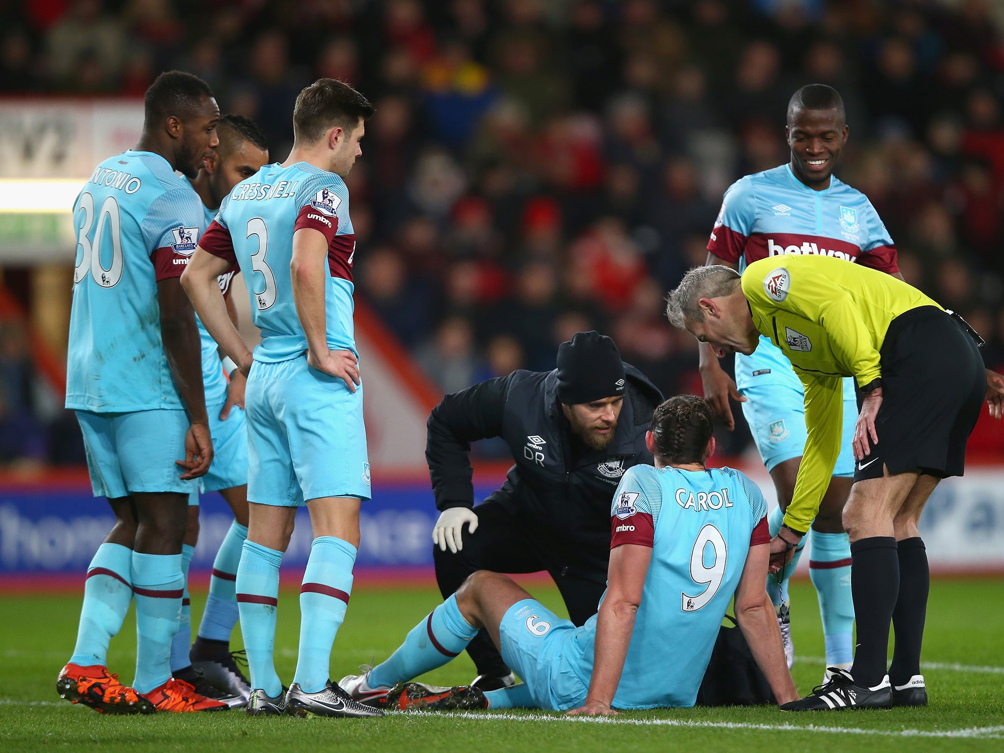 Concerned teammates surround Andy Carroll as he is treated for his latest injury.