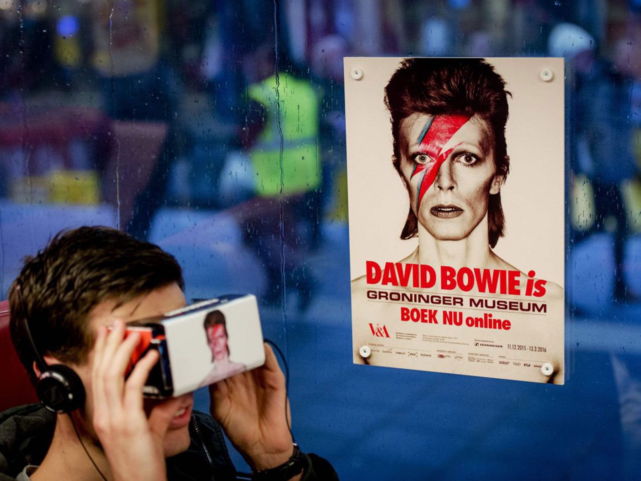 People take a virtual journey through the life of David Bowie on the train from Zwolle to Groningen, Holland, on Monday. Bowie correctly predicted the impact the internet would have on the music industry