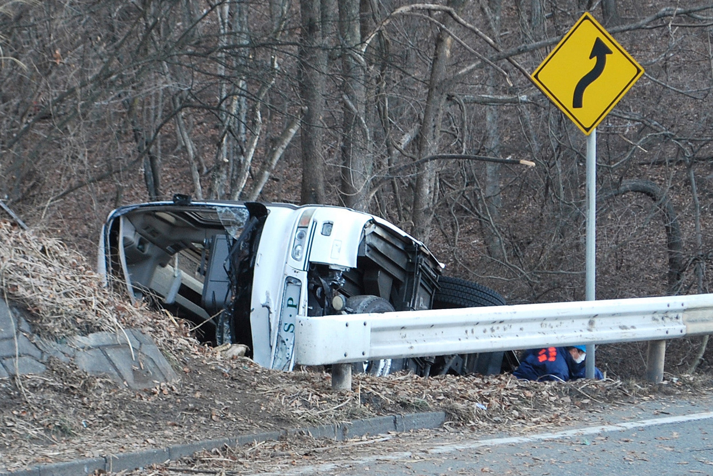 Japanese TV networks showed a white bus lying on its side in a ditch. The front of the vehicle, with its shattered windscreen, appeared to have suffered the worst damage