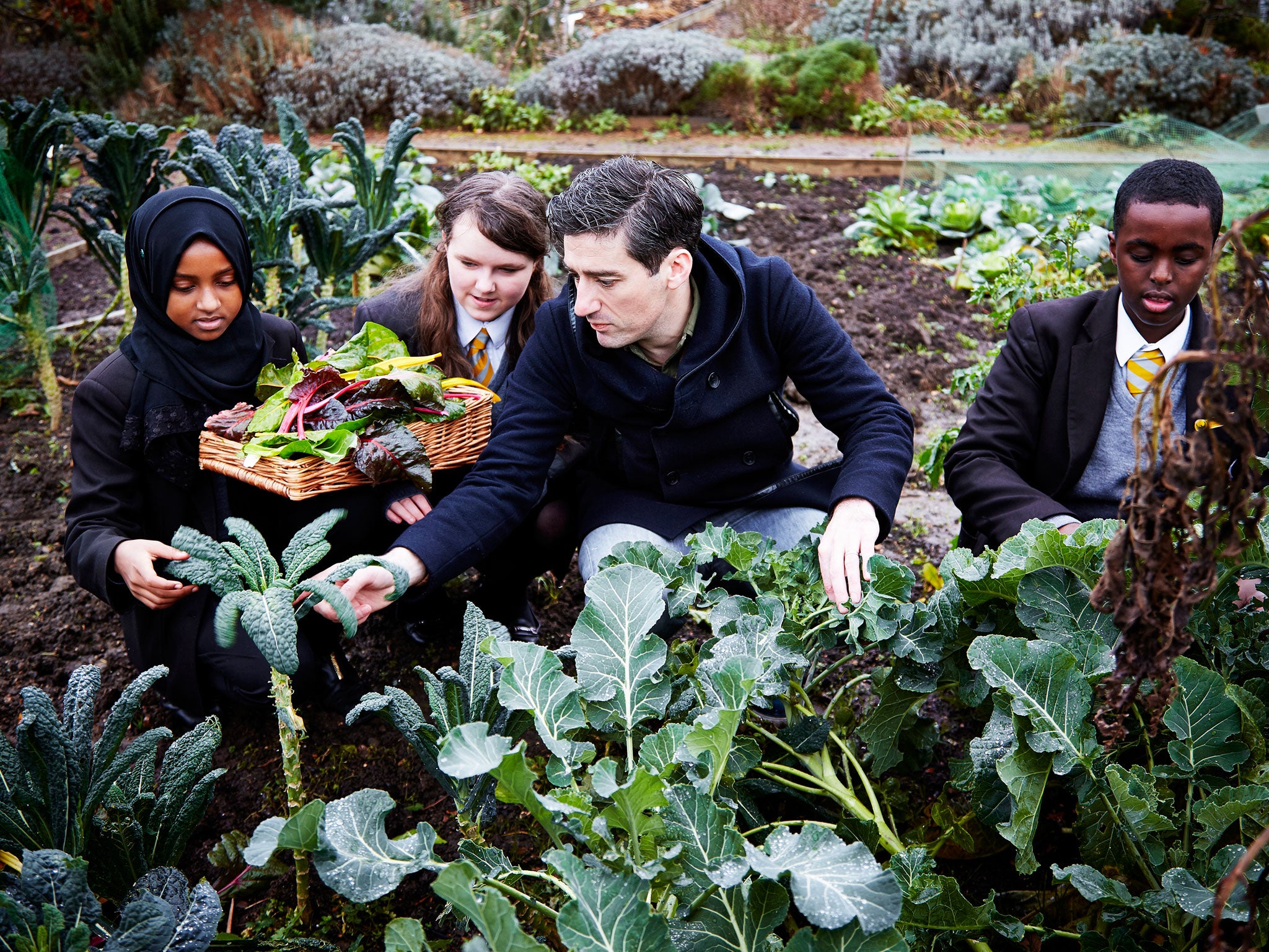 Ben Tish selects vegetables with the pupils at Phoenix High School