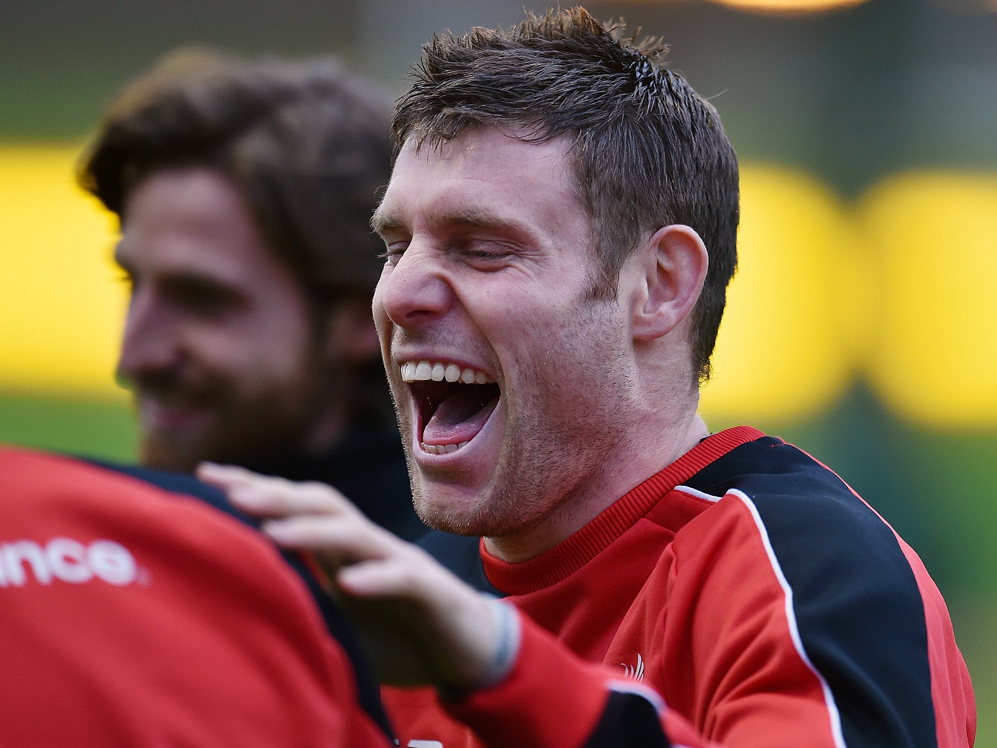 Milner enjoys a joke with his teammates during training at Melwood